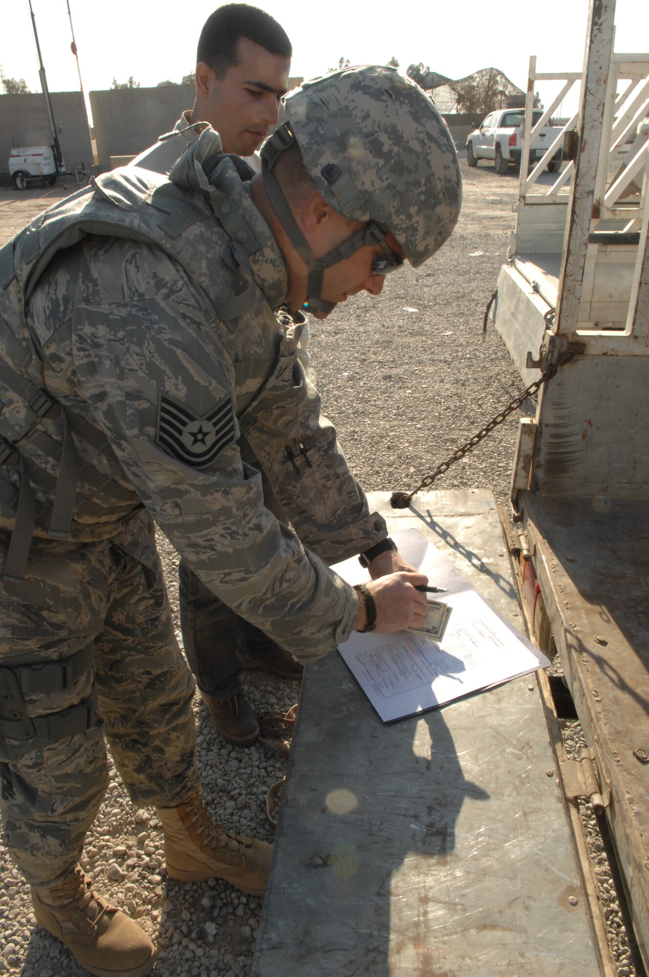 KIRKUK REGIONAL AIR BASE, Iraq – Tech. Sgt. Jason Daniels counts money for an Iraqi vendor as payment for furniture purchased for squadron offices here Jan. 22. The 506th Air Expeditionary Group Financial Management paying agent was recently named Financial Management Noncommissioned Officer of the Year for the Air Force Reserve Command. He is deployed from the 340th Flying Training Group, Randolph AFB, Texas, and is a native of Cambridge, Minn. (U.S. Air Force photo illustration / Senior Airman Jessica Lockoski)