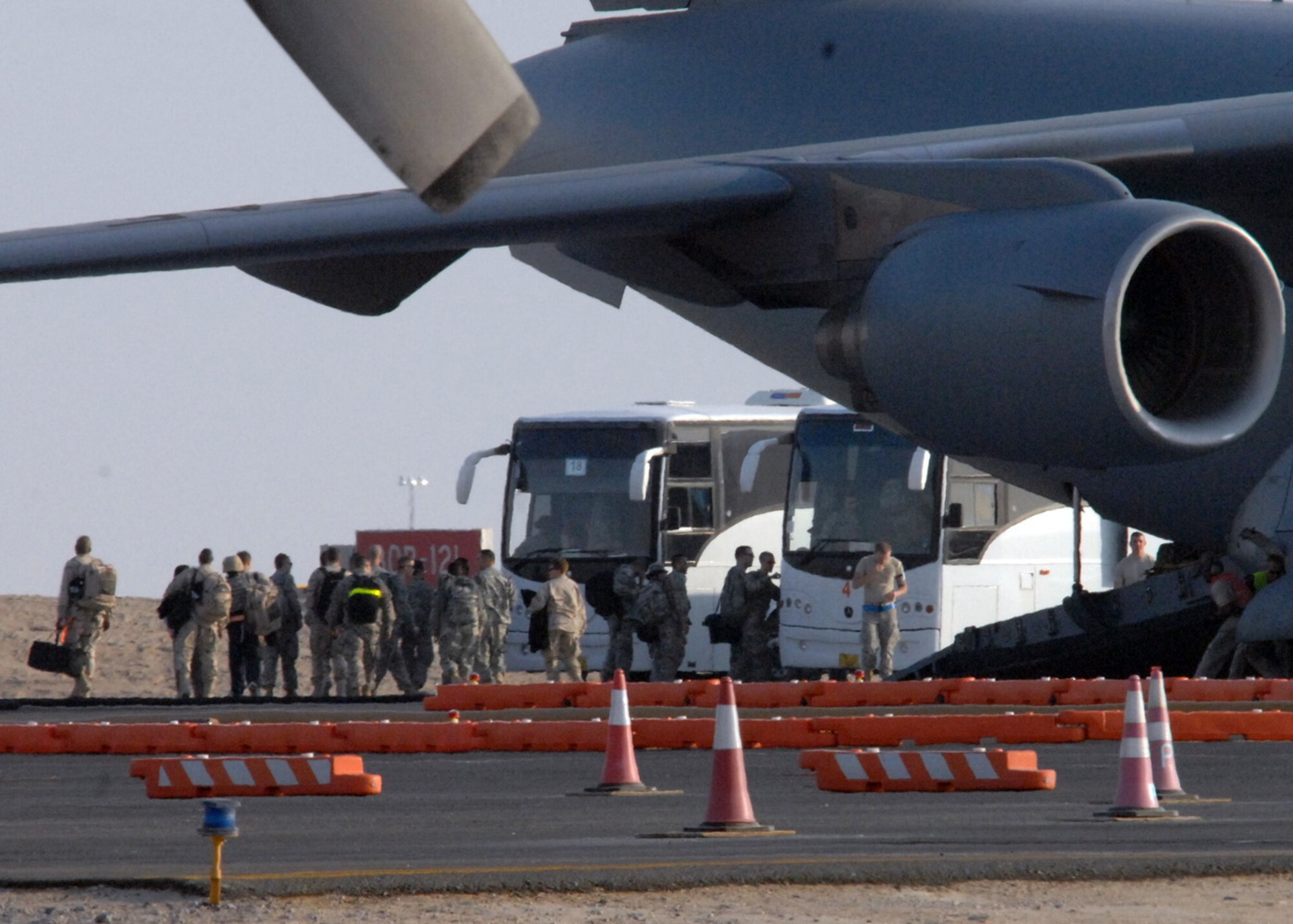 SOUTHWEST ASIA ? Army Soldiers line up to get on buses at an air base in Southwest Asia after their flight from Afghanistan, Jan. 28. In 2008, the 386th Expeditionary Logistics Readiness Squadron moved more than 765,000 personnel into and out of Iraq and Afghanistan, more than 40,000 more than the previous year. (U.S. Air Force photo/ Senior Airman Courtney Richardson)