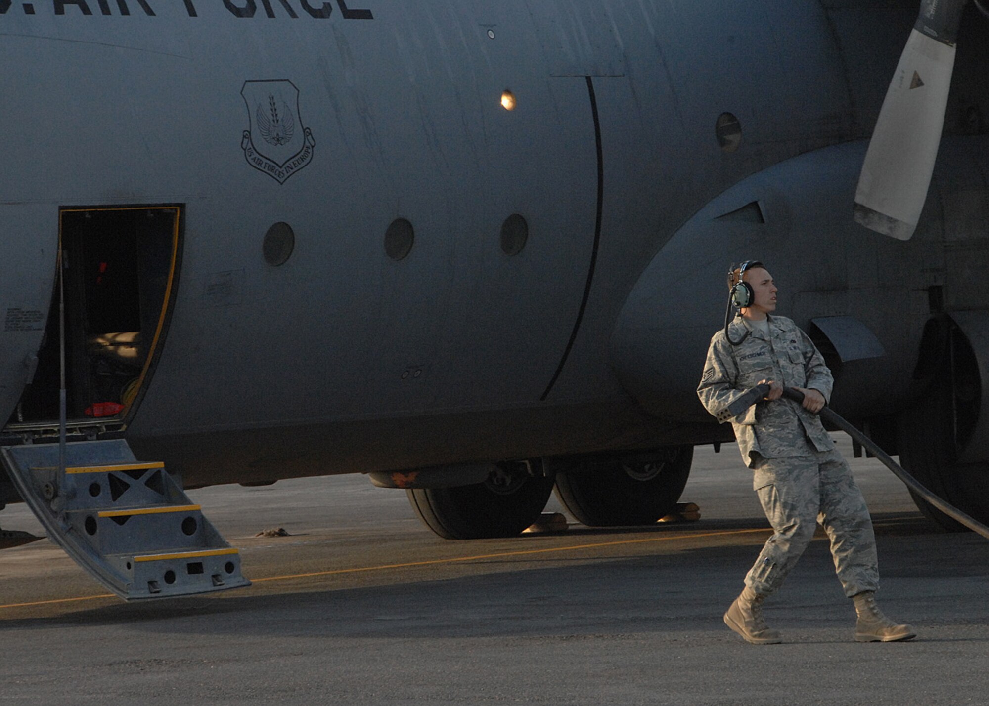 SOUTHWEST ASIA -- Staff Sgt. Brad Kretschmer, C-130 crew chief, prepares to complete a maintenance check after it completed it's final mission at an air base in Southwest Asia, Jan. 28. When C-130s reach 38,000 hours it can only be used for training purposes until it reaches 45,000 hours. (U.S. Air Force photo/Senior Airman Courtney Richardson)