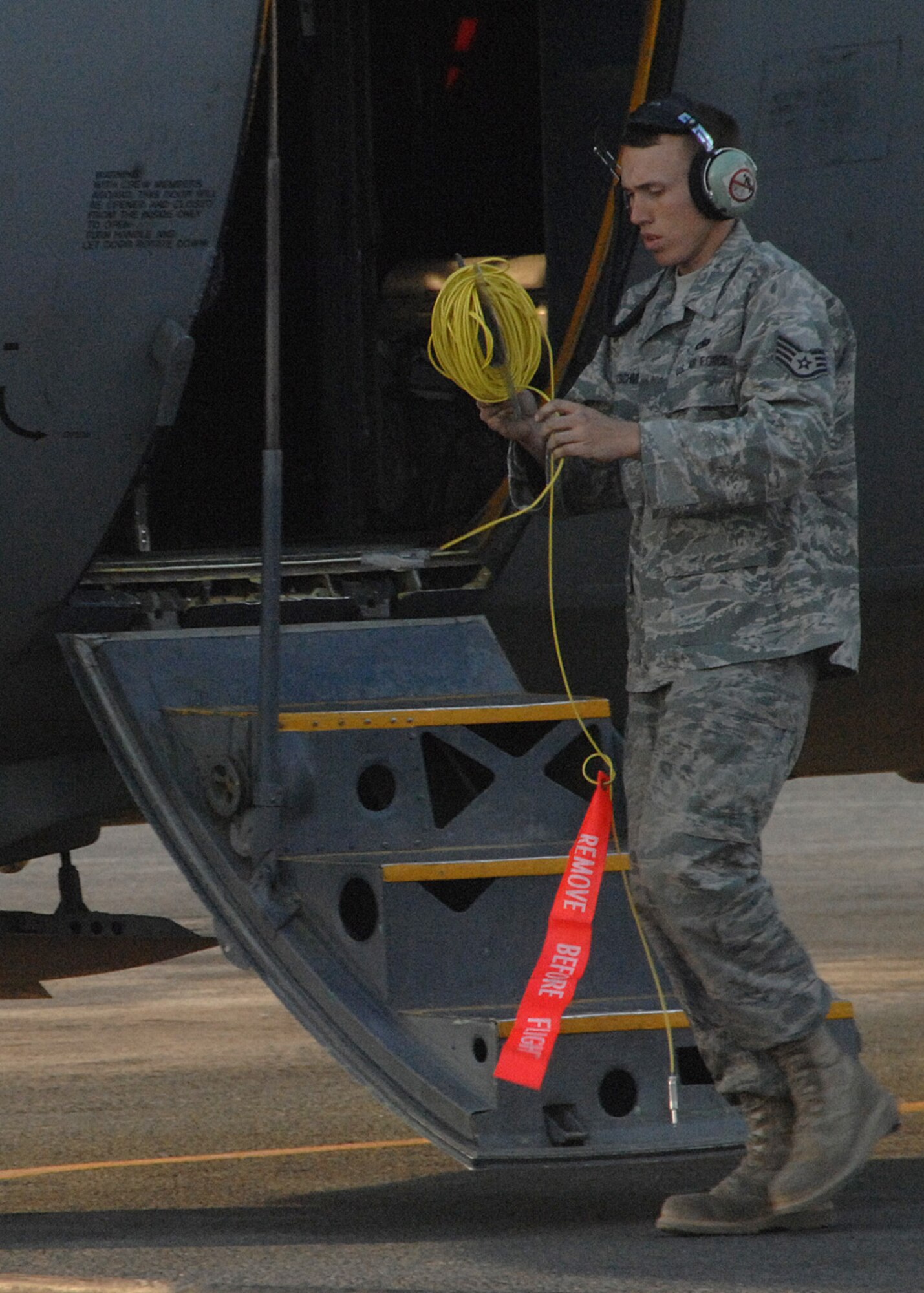SOUTHWEST ASIA -- Staff Sgt. Brad Kretschmer, C-130 crew chief, uncoils cable in the process of completing his maintenance check after his C-130 completed its final mission at an air base in Southwest Asia, Jan. 28. Sergeant Kretschmer has been the crew chief for this aircraft for the last three years, and will fly with the aircraft back to Germany. (U.S. Air Force photo/Senior Airman Courtney Richardson)