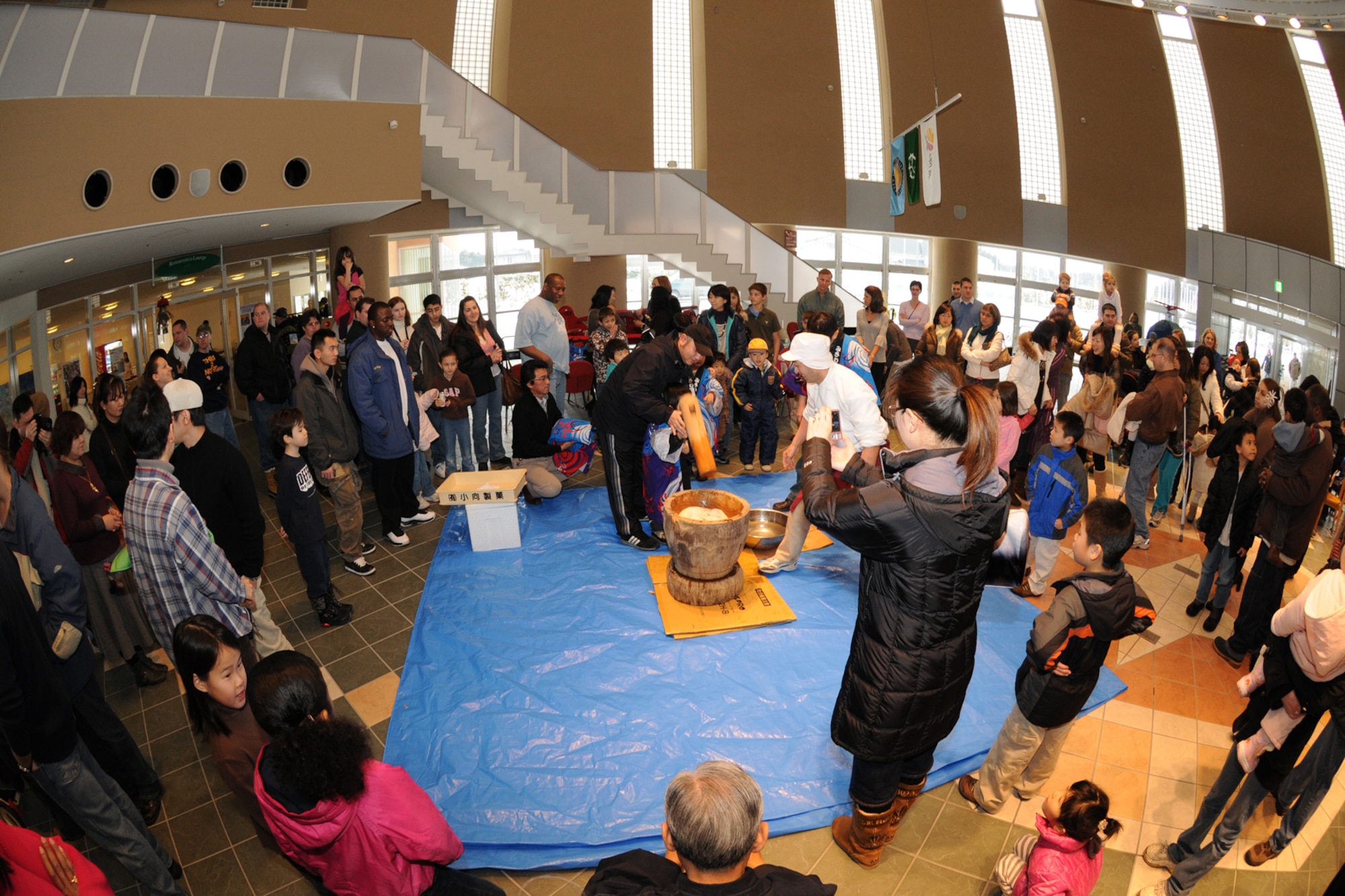 MISAWA CITY, Japan -- Members of the Misawa community gather to watch rice pounding during a Shougatsu celebration Jan. 25, 2009, at the Misawa International Center. In addition to rice pounding, families were able to make and enjoy sushi and practice calligraphy. (U.S. Air Force photo by Senior Airman Jamal D. Sutter) 