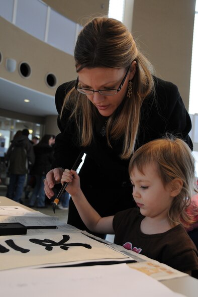 MISAWA CITY, Japan -- Shelley Lucero, wife of Tech. Sgt. Quentin Lucero, 35th Communications Squadron, and daughter, Sierra, practice calligraphy during a Shougatsu celebration Jan. 25, 2009, at the Misawa International Center. Shougatsu is one of the most important holidays in Japan, when families usually gather to spend time together. (U.S. Air Force photo by Senior Airman Jamal D. Sutter) 