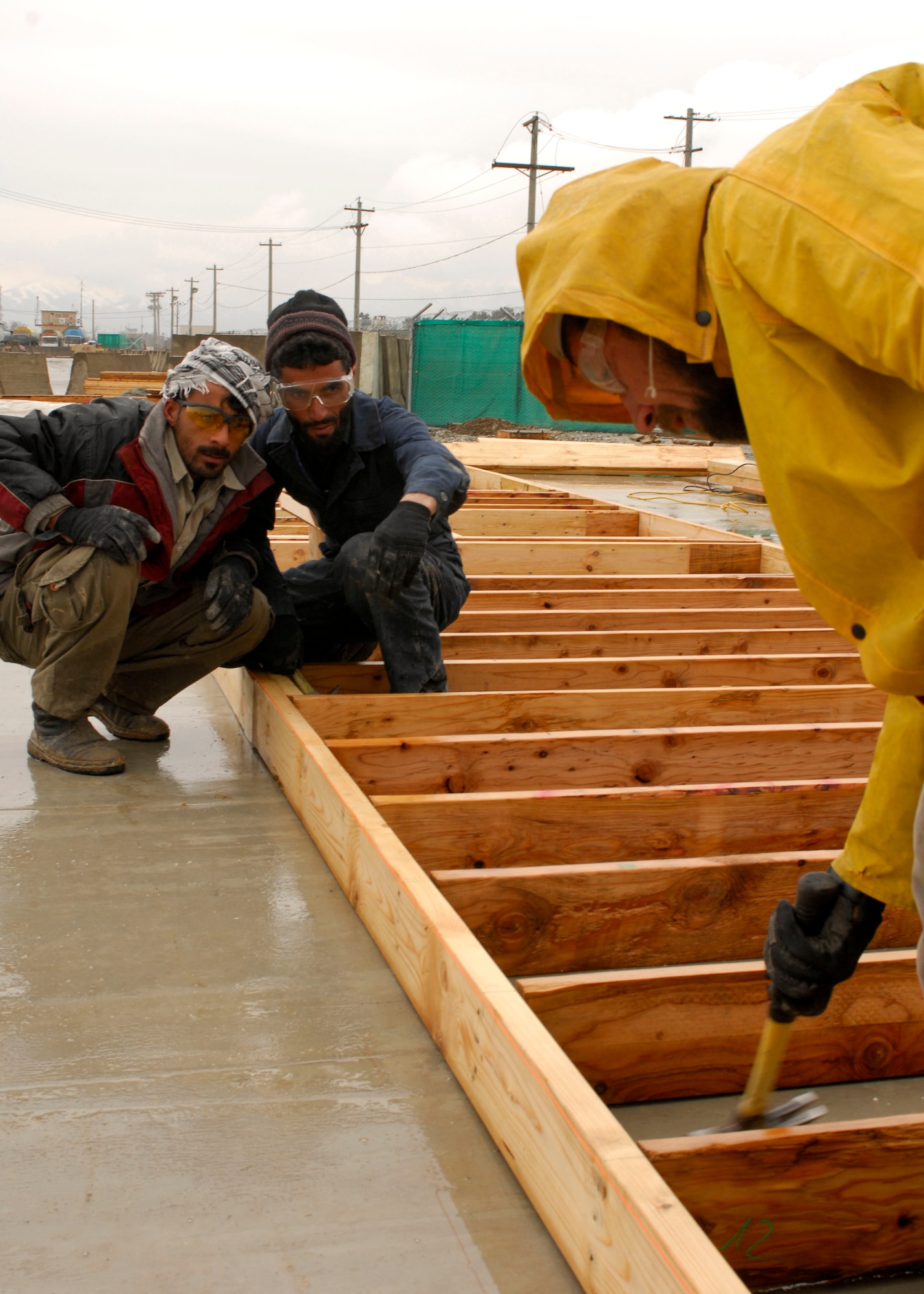 Three local contractors create the foundation for an extension of Entry
Control Point One under the supervision of Airmen from the 755th Expeditionary Civil Engineer Squadron at Bagram Air Field, Afghanistan, Jan 26. A new job training program created by the 755th ECES allows local nationals to improve their construction skills and improve their quality of life. This extension will improve access for nationals transiting the gate. (U.S. Air Force photo/ Senior Airman Erik Cardenas)(Released) 