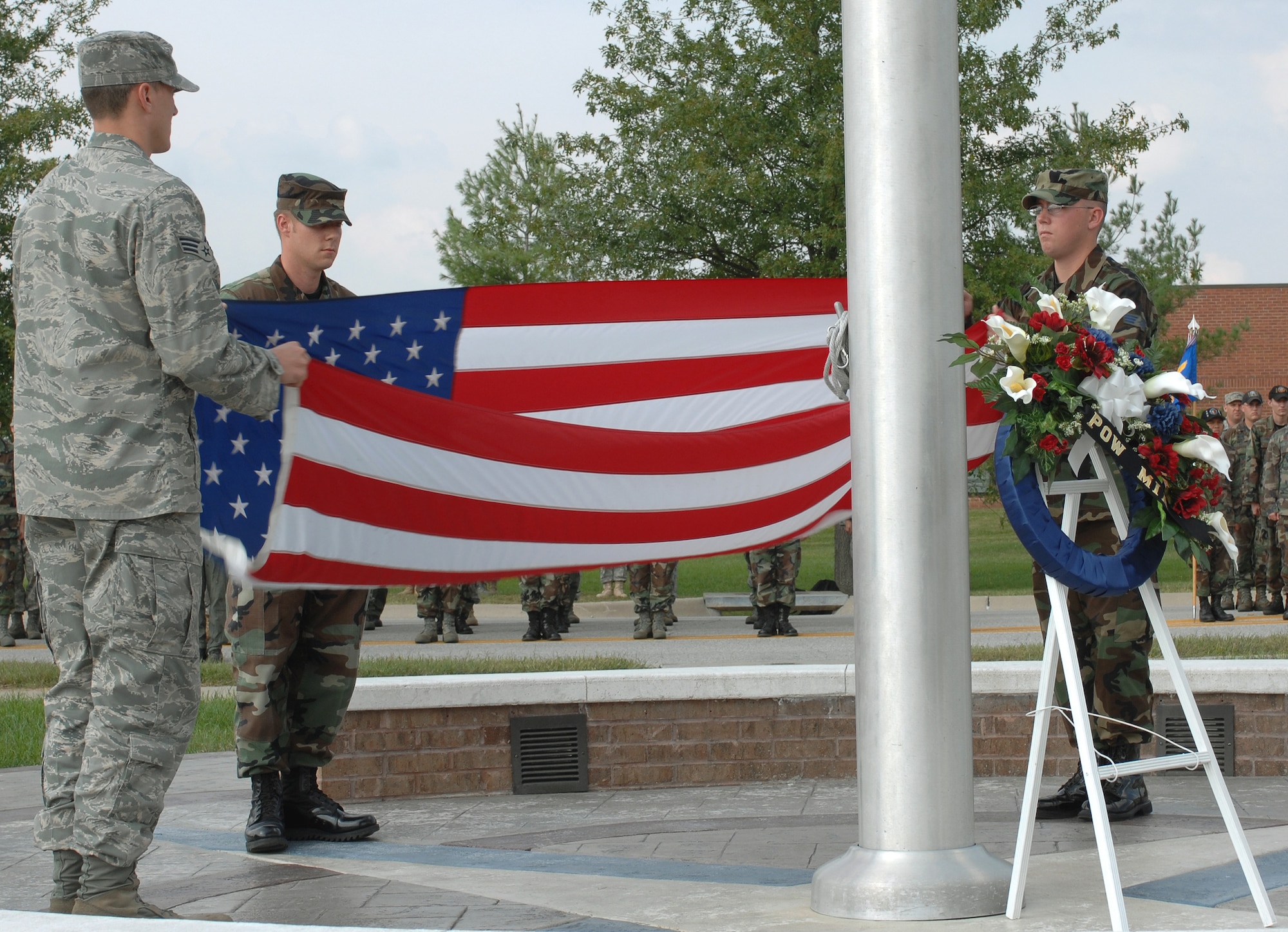 WHITEMAN AIR FORCE BASE, Mo. -Senior Airmen currently attending Airman Leadership School fold the flag during the Retreat ceremony following the annual Prisoner of War/Missing in Action ceremony Sept. 19. More than 150 members of Team Whiteman participated in the ceremony. (U.S. Air Force photo/Staff Sgt Charles D. Larkin Sr.)