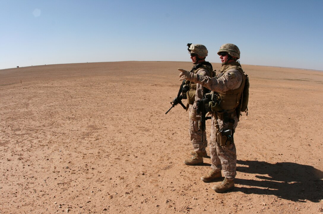 Maj. Todd Peppe (left), the 2nd Battalion, 25th Marine Regiment’s Headquarters and Service Company commander and camp commandant for Camp Korean Village, Iraq, inspects the outer perimeter of the base’s security with Gunnery Sgt. Trent Narra, the company gunny and assistant camp commandant Jan. 30.  Camp Korean Village, located in the western region of Iraq’s Al Anbar Province, is a key Coalition logistics hub and base of operations for service members from the U.S. Army, Navy and Marine Corps.  (Official USMC photo by Capt. Paul L. Greenberg)