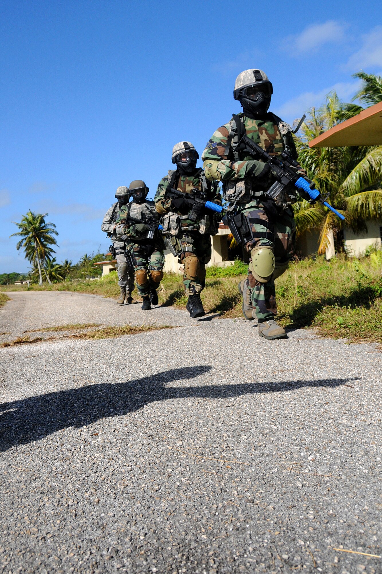 ANDERSEN AIR FORCE BASE, Guam - Commando Warrior Cadre Tech Sgt. Rudy Aguirre points the Kulis Air National Guard Security Forces members to the designated training area here during Commando Warrior Urban Operations exercise 09-1Jan. 31. The mission of the Regional Training Center of Commando Warrior is to enhance the combat readiness of PACAF forces through training and evaluation of force protection and ground combat skills. (U.S. Air Force photo by Airman 1st Class Courtney Witt)