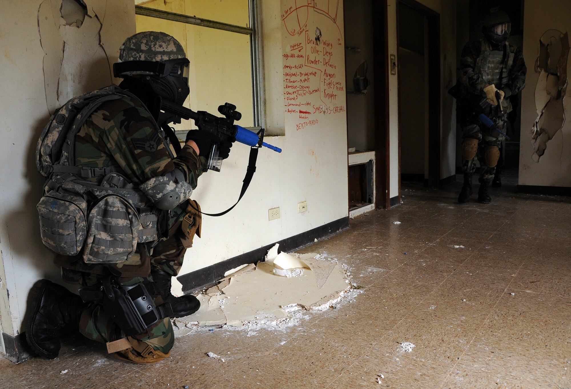 ANDERSEN AIR FORCE BASE, Guam - Senior Airman Wyatt Derner, Security Forces member out of Kulis Air National Guard, takes a knee as members of his team check the house for potential "enemies" during Commando Warrior Urban Operations exercise 09-1 here Jan. 31. Approximately 1,500 students attend these courses annually to meet PACAF's training and deployment requirements. (U.S. Air Force photo by Airman 1st Class Courtney Witt)
