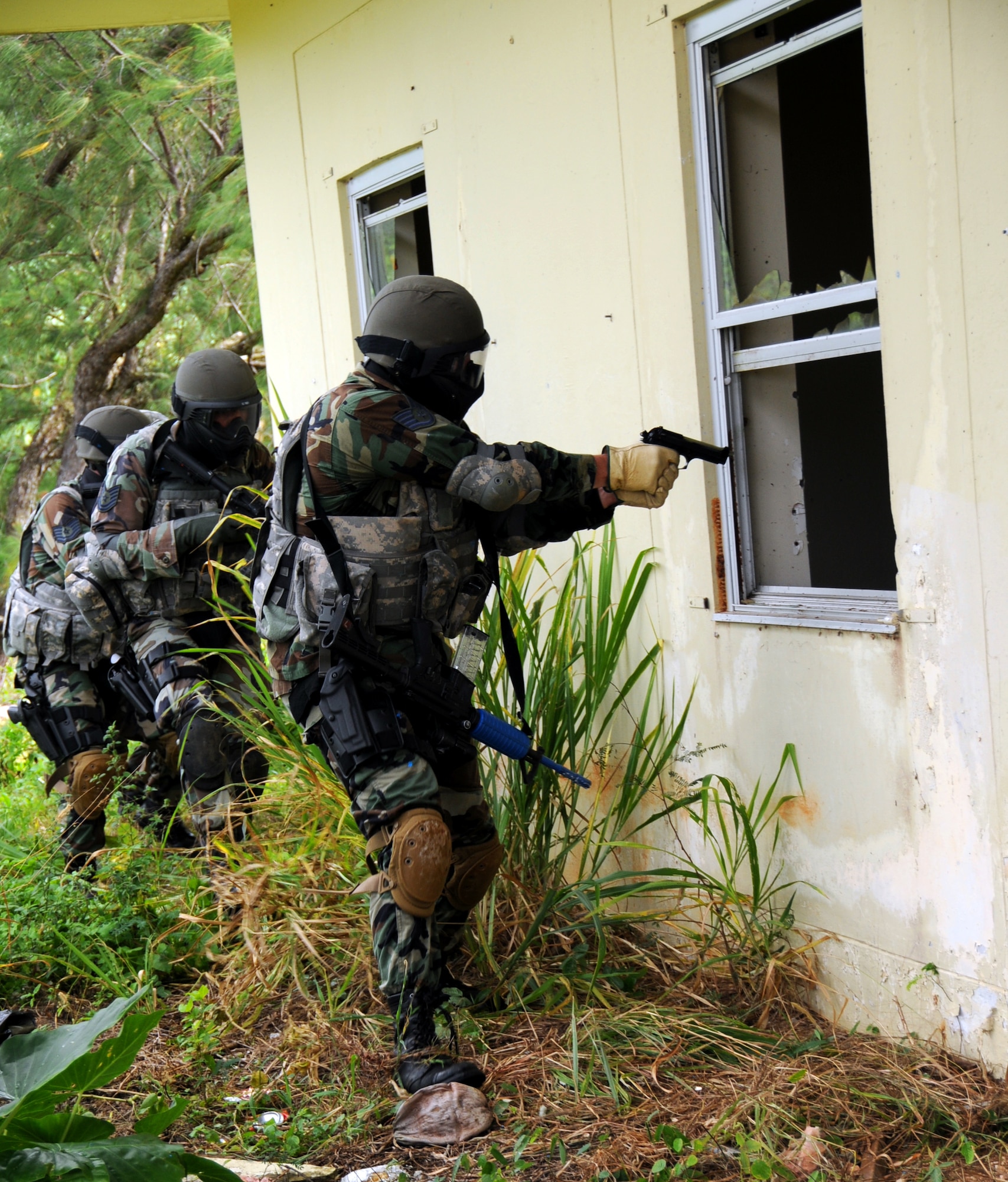 ANDERSEN AIR FORCE BASE, Guam - Security Forces members out of the 176th Wing, Kulis Air National Guard perform a quick check before entering a house here during the Commando Warrior Urban Operations exercise 09-1, Jan 31. The mission of the Regional Training Center of Commando Warrior is to enhance the combat readiness of PACAF forces through training and evaluation of force protection and ground combat skills. (U.S. Air Force photo by Airman 1st Class Courtney Witt)
