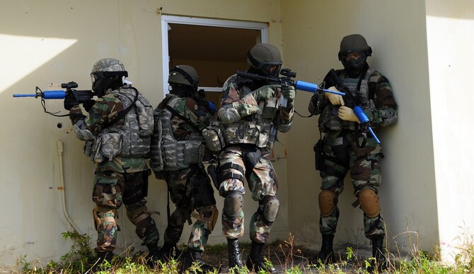 ANDERSEN AIR FORCE BASE, Guam - Security Forces members out of the 176th Wing, Kulis Air National Guard, perform a quick check before entering a house here during the Commando Warrior Urban Operations exercise 09-1,Jan 31. The mission of the Regional Training Center of Commando Warrior is to enhance the combat readiness of PACAF forces through training and evaluation of force protection and ground combat skills. (U.S. Air Force photo by Airman 1st Class Courtney Witt)