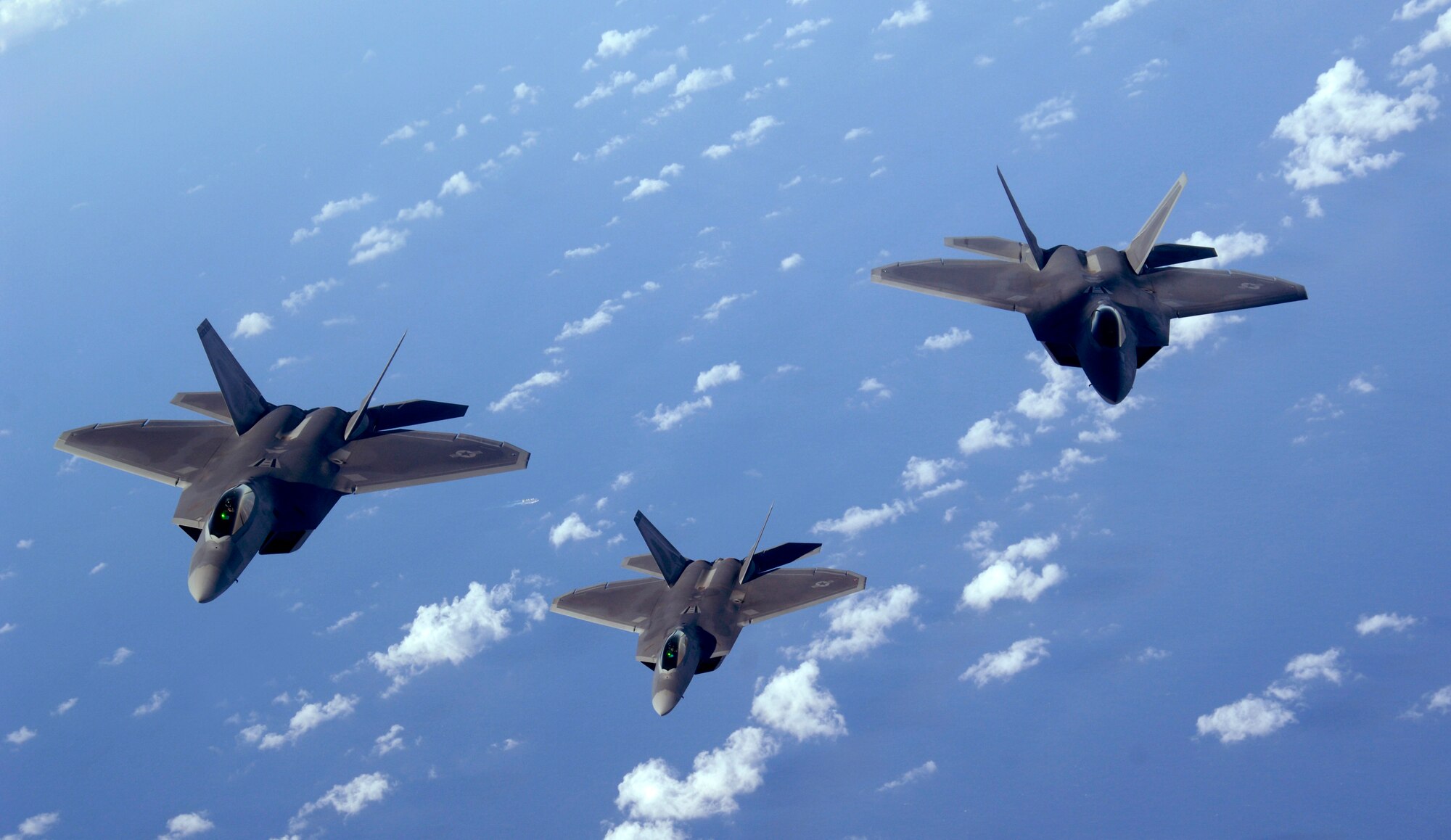 ANDERSEN AIR FORCE BASE, Guam - A three-ship of F-22 Raptors fly over the Pacific Ocean Jan. 28. The Raptors are deployed from Elmendorf AFB, Alaska, to the 90th Expeditionary Fighter Squadron at Andersen AFB, Guam. Andersen received 12 of the $140 million dollar aircraft and more than 250 Airmen have arrived at the base for a three-month deployment as part of the Pacific's Theater Security Package. The stealth-fighters, along with associated maintenance and support personnel will participate in various exercises that provide routine training in an environment different from their home station.  (U.S. Air Force photo Master Sgt. Kevin J. Gruenwald) 






















  












 











































  












 

























