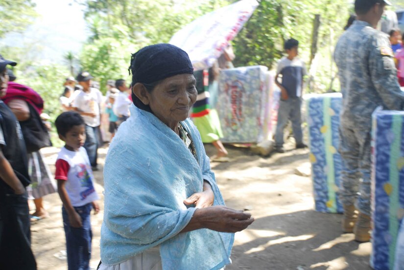 SOTO CANO AIR BASE, Honduras - A woman from El Mangos, Honduras, waits to receive a mattress being distributed by Joint Task Force-Bravo personnel Jan. 30.  Altogether, the men and women of JTF-B distributed more than 200 mattresses to people in three remote villages.  (US Air Force photo/Tech Sgt. Rebecca Danét)