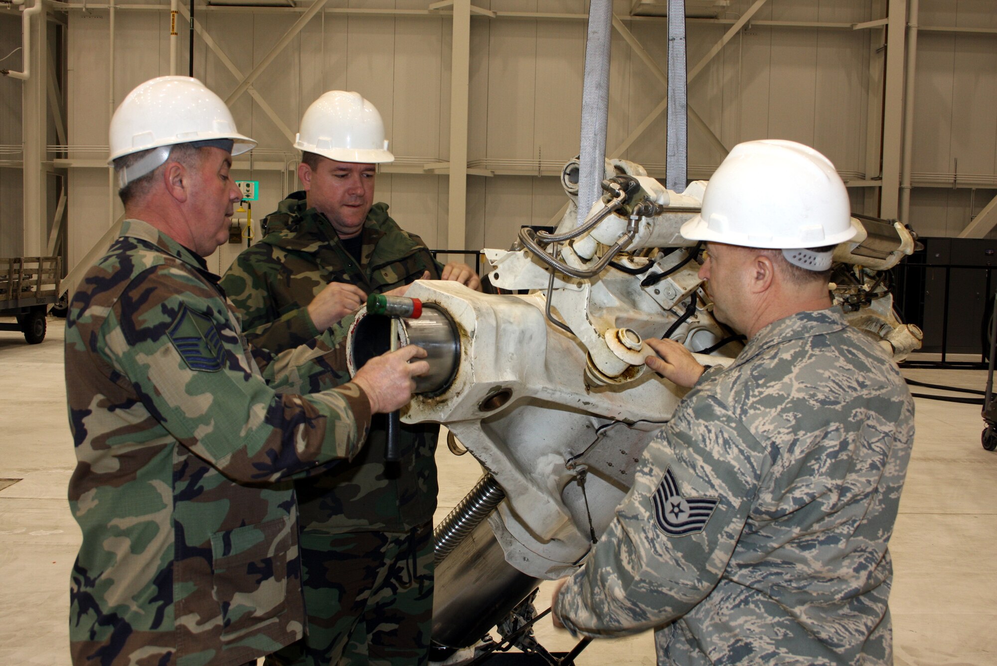 WRIGHT-PATTERSON AFB, Ohio - Master Sgt. Stan Evans, Staff Sgt. Greg Cyrus, and Tech. Sgt. Gerald Keating, all with the 445th Maintenance Squadron, prepare a broken strut for shipment to the repair depo at Hill Air Force Base. (Air Force photo/Senior Airman Ken LaRock)