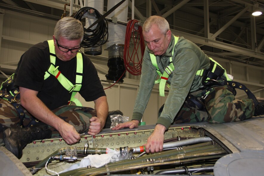 WRIGHT-PATTERSON AFB, Ohio - Technical Sgt. Harold Rogers and Master Sgt. Greg Kern, Aircraft Structures Technicians, 445th Airlift Wing Maintenance Squadron, are replacing the Hydroline Adel Clamp Brackett in the fuel cell on a C-5 Galaxy aircraft. (Air Force photo/SrA Ken LaRock)