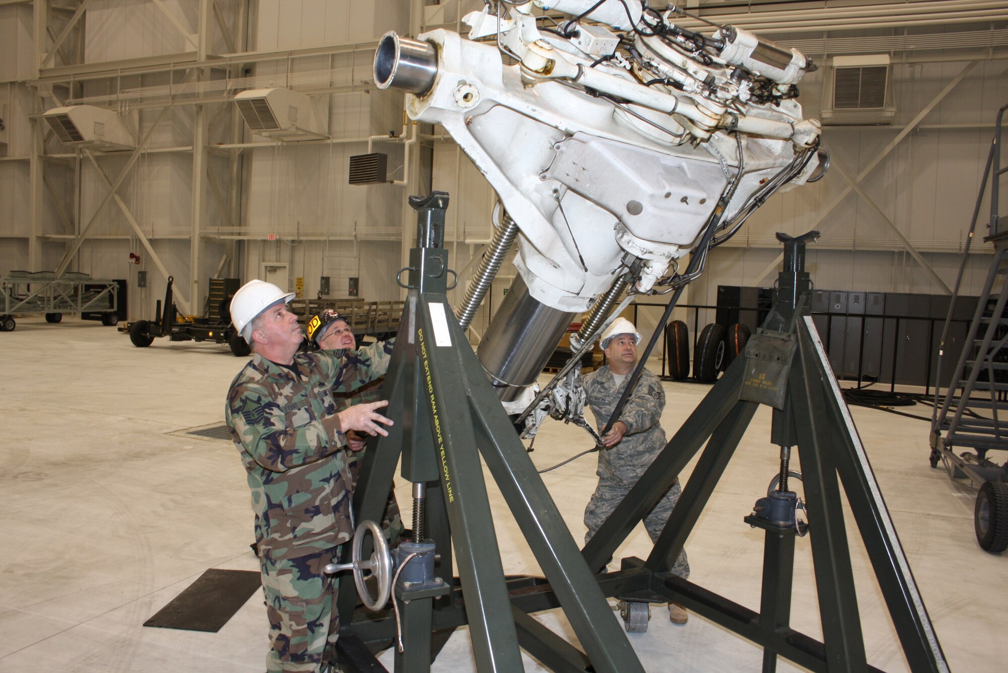 WRIGHT-PATTERSON AFB, Ohio - Master Sgt. Stan Evans, Staff Sgt. Scott Spielman, and Tech. Sgt. Gerald Keating, all with the 445th Maintenance Squadron, prepare a broken strut for shipment to the repair depo at Hill Air Force Base. (Air Force photo/Senior Airman Ken LaRock)