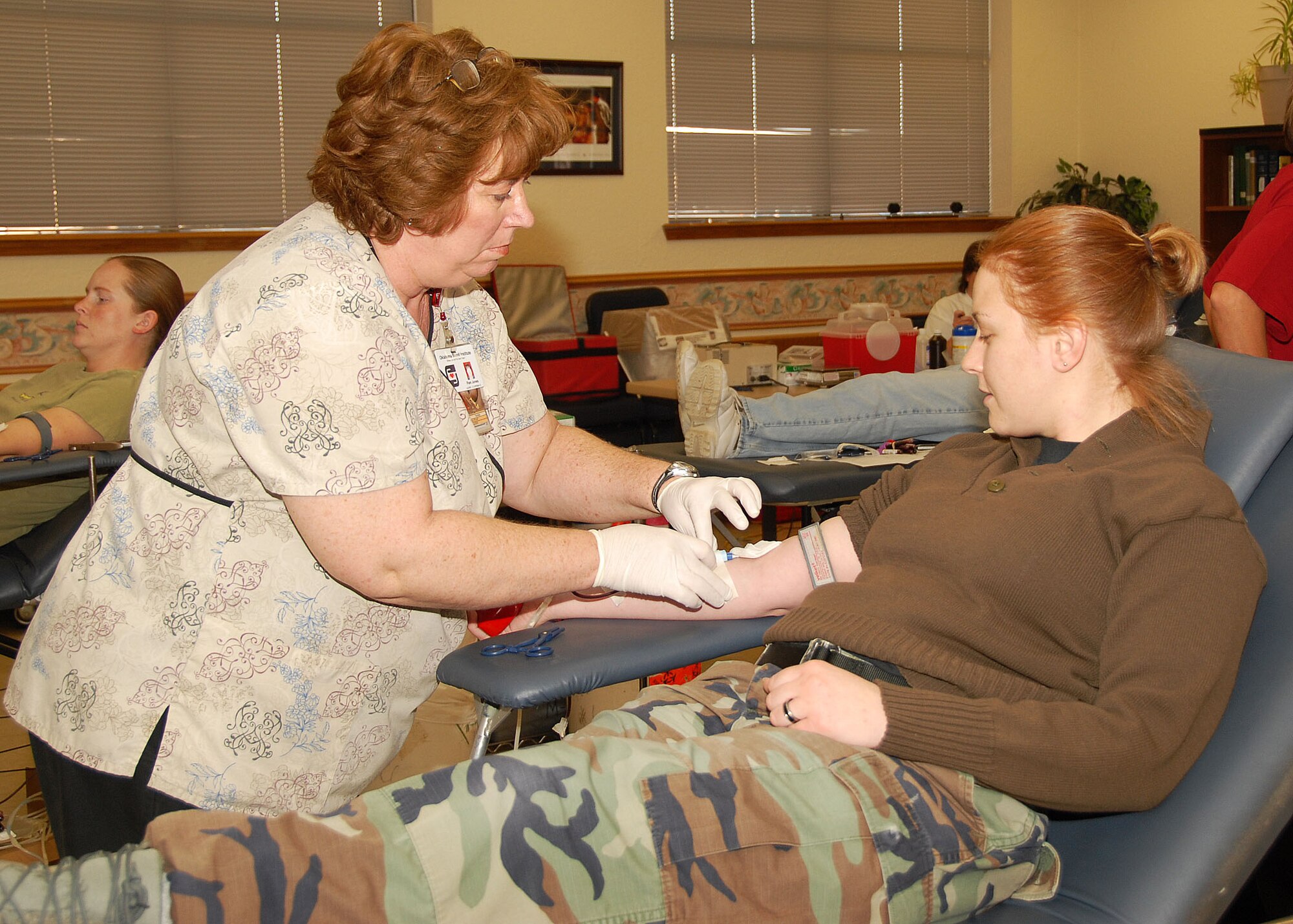ALTUS AIR FORCE BASE, Okla. -- Pam Jones, a nurse from the Oklahoma Blood Institute, extracts a needle from Senior Airman Beth Basinger's arm during a blood drive at the base chapel Jan. 30. More than 40 base personnel donated blood during the drive. Airman Basinger is assigned to the 97th Operational Support Squadron. (U.S. Air Force photo/Airman 1st Class Marianne E. Lane)