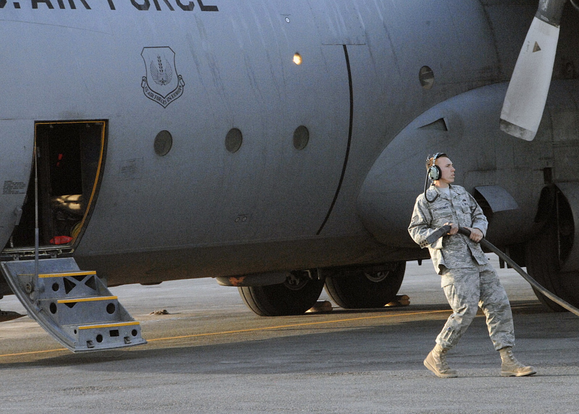 Staff Sgt. Brad Kretschmer, crew chief for C-130 Hercules no. 1847 at an air base in Southwest Asia, finishes his maintenance check after his C-130 completed its final combat mission Jan. 28.  After 47 years of service, the aircraft is being retired.  Sergeant Kretschmer has been the crew chief for this aircraft for the last three years, and will fly with the aircraft back to Germany. (U.S. Air Force photo/Senior Airman Courtney Richardson)