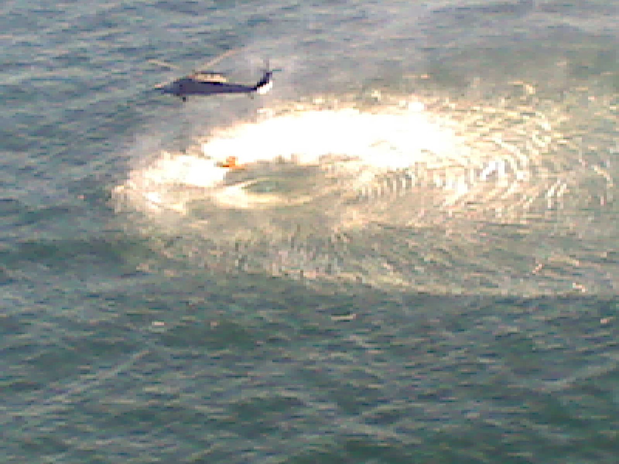 An HH-60G Pave Hawk helicopter from the California Air National Guard's 129th Rescue Wing, Moffett Federal Airfield, hovers above the survivor of a small plane crash, Jan. 29, approximately 10 miles west of Pillar Point, Calif. The rescue helicopter hoisted the man and transported him to Coast Guard Air Station San Francisco where he was treated for hypothermia and later transferred to San Francisco General Hospital by local emergency medical services. It was the 129th Rescue Wing's 599th rescue. (Coast Guard Photo) 
