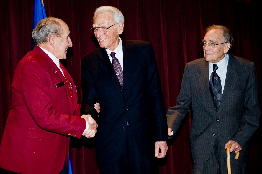 Army Air Corps veteran Joseph Moser, left, is congratulated by fellow decorated pilots Al Mills, center, and Bob Milliken, right, who flew with him during World War II. Mr. Moser received the Distinguished Flying Cross at McChord's Annual Awards Banquet Jan. 29. (U.S. Air Force photo/Abner Guzman)