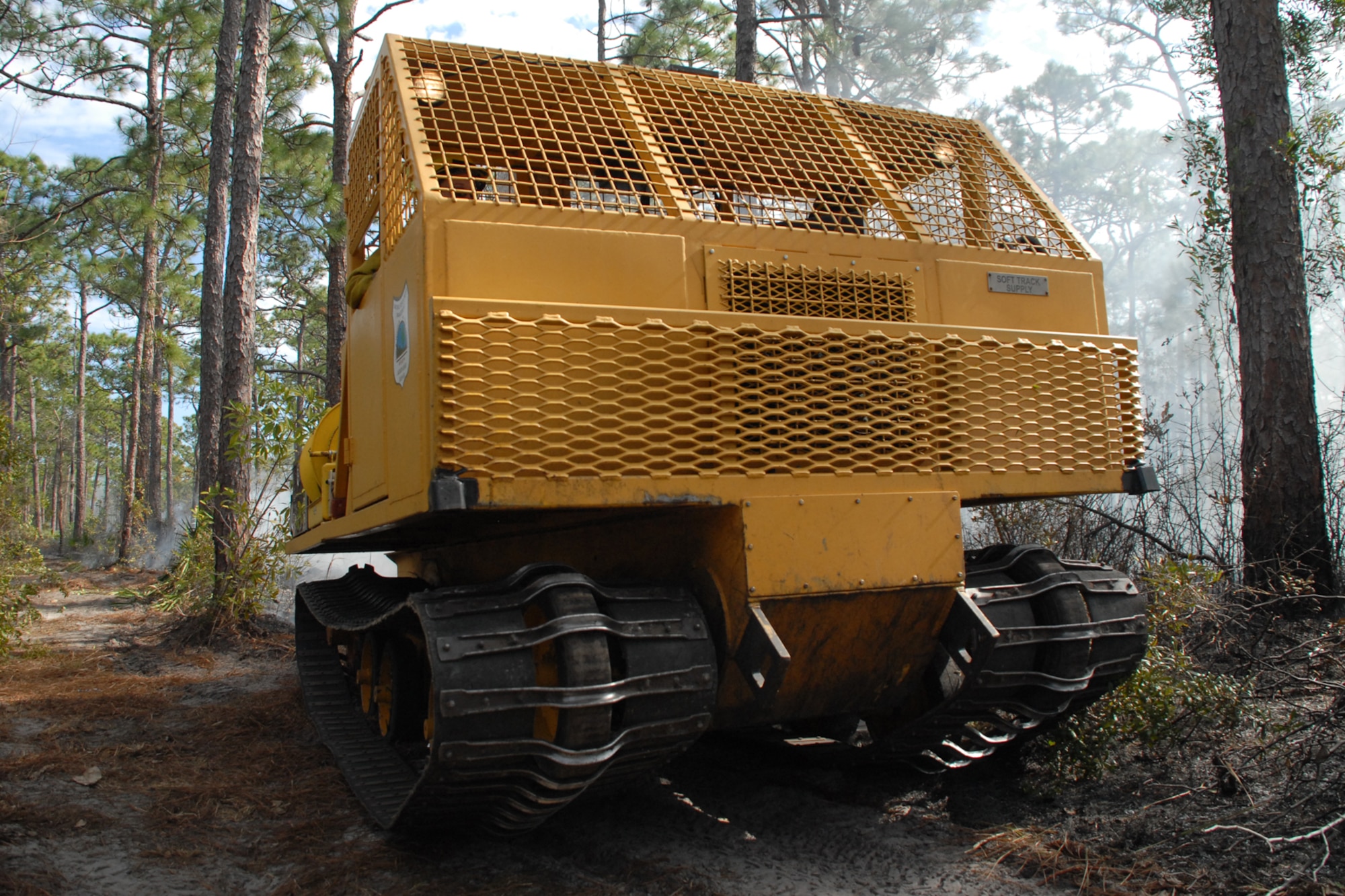 EGLIN AIR FORCE BASE, Fla. -- A soft trac vehicle is used by Jackson Guard forestry technicians and wildland fire specialists during a prescribed burn at White Point, an 85-acre recreation area on the Choctawhatchee Bay Jan. 29. The vehicle is designed for navigation in areas with a soft or muggy ground. Many native plants and animal species depend on Eglin's fire-dependent long-leaf pine ecosystem, 11 of which are federally protected. Endangered species such as the red-cockaded woodpecker, depend on fire that is typically caused by either lightning strikes or Eglin's resident fire managers to survive. As of the 2008 control burn season, Jackson Guard's five-year average is 73,000 acres burned annually. (U.S. Air Force Photo by Staff Sgt. Mike Meares)