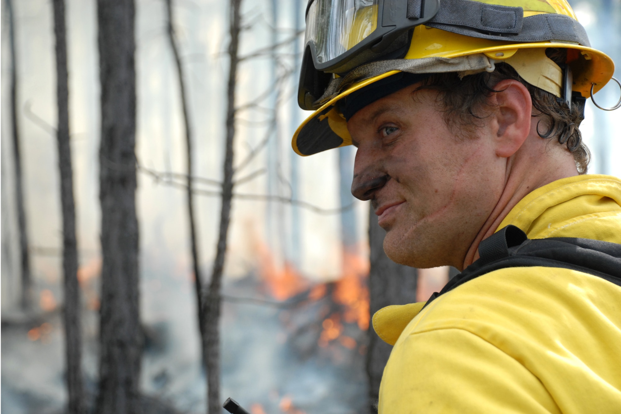 EGLIN AIR FORCE BASE, Fla. -- Hollister Hurt, a Jackson Guard forestry technician and wildland fire specialist, monitors the progress of a fire set for a prescribed burn at White Point, an 85-acre recreation area on the Choctawhatchee Bay Jan. 29. Many native plants and animal species depend on Eglin's fire-dependent long-leaf pine ecosystem, 11 of which are federally protected. Endangered species such as the red-cockaded woodpecker, depend on fire that is typically caused by either lightning strikes or Eglin's resident fire managers to survive. As of the 2008 control burn season, Jackson Guard's five-year average is 73,000 acres burned annually. (U.S. Air Force Photo by Staff Sgt. Mike Meares)