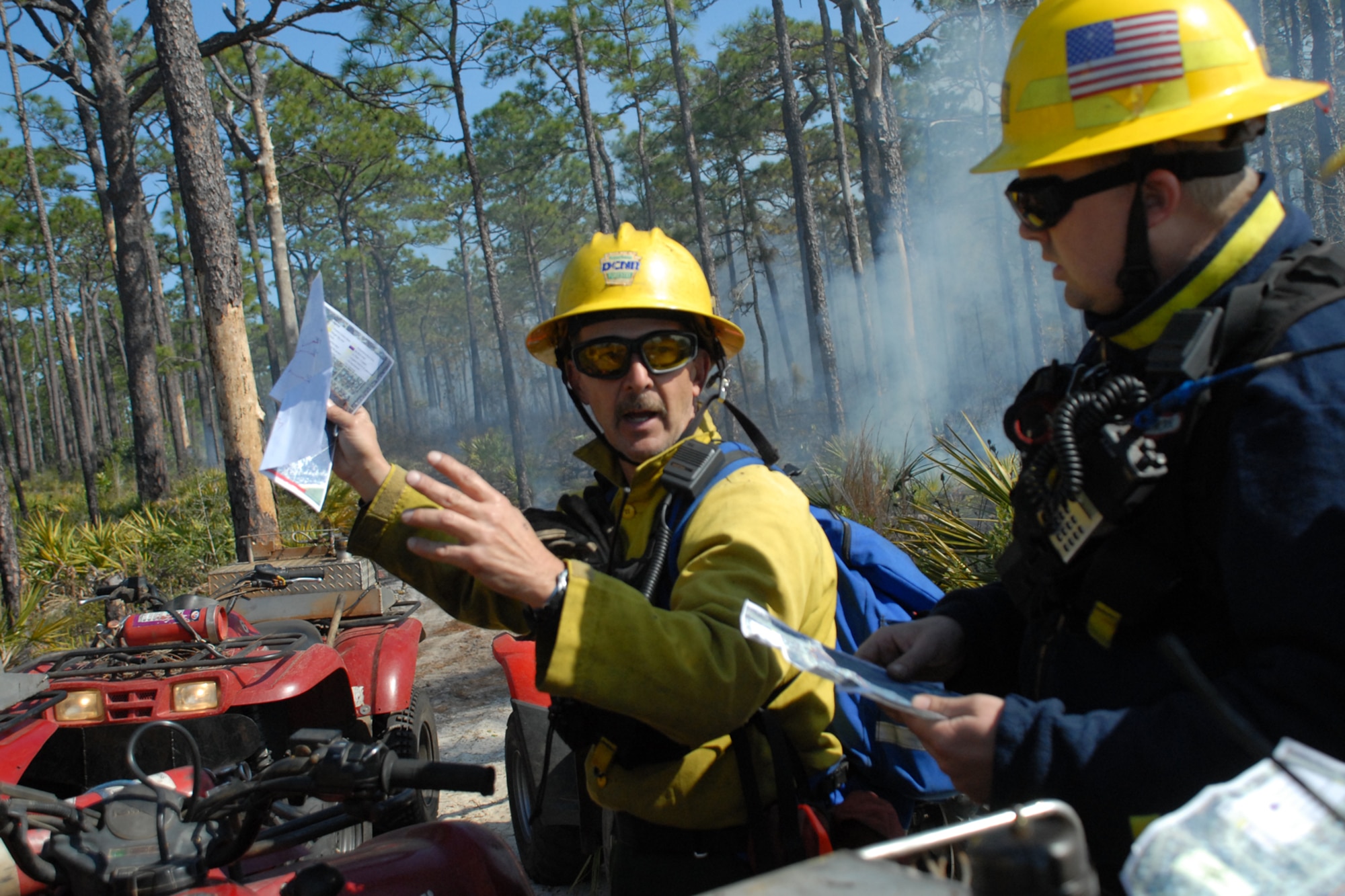 EGLIN AIR FORCE BASE, Fla. -- Keith Hawk, a Jackson Guard forestry technician and wildland fire specialist, goes over the plan for the for a prescribed burn at White Point, an 85-acre recreation area on the Choctawhatchee Bay Jan. 29. As the winds shift throughout the day, the burn plan is adjusted accordingly. Many native plants and animal species depend on Eglin's fire-dependent long-leaf pine ecosystem, 11 of which are federally protected. Endangered species such as the red-cockaded woodpecker, depend on fire that is typically caused by either lightning strikes or Eglin's resident fire managers to survive. As of the 2008 control burn season, Jackson Guard's five-year average is 73,000 acres burned annually. (U.S. Air Force Photo by Staff Sgt. Mike Meares)
