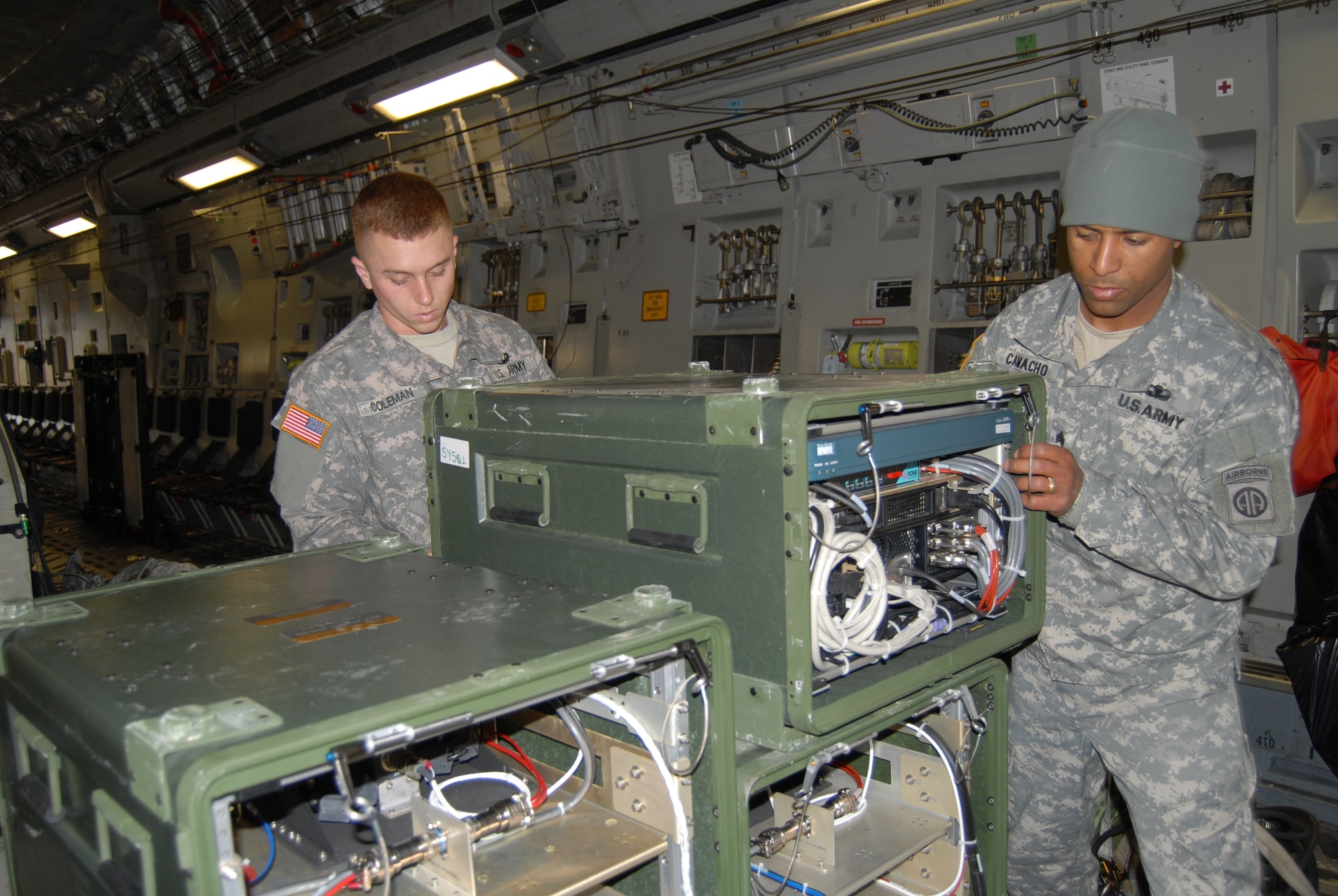 Private 1st Class Jeffrey Coleman and Sgt. Amadison Camacho, 82nd Airborne Division,  set up a reconfiguration for a troop jump during the JFEX Tuesday. (U.S. Air Force Photo by Airman 1st Class Mindy Bloem)