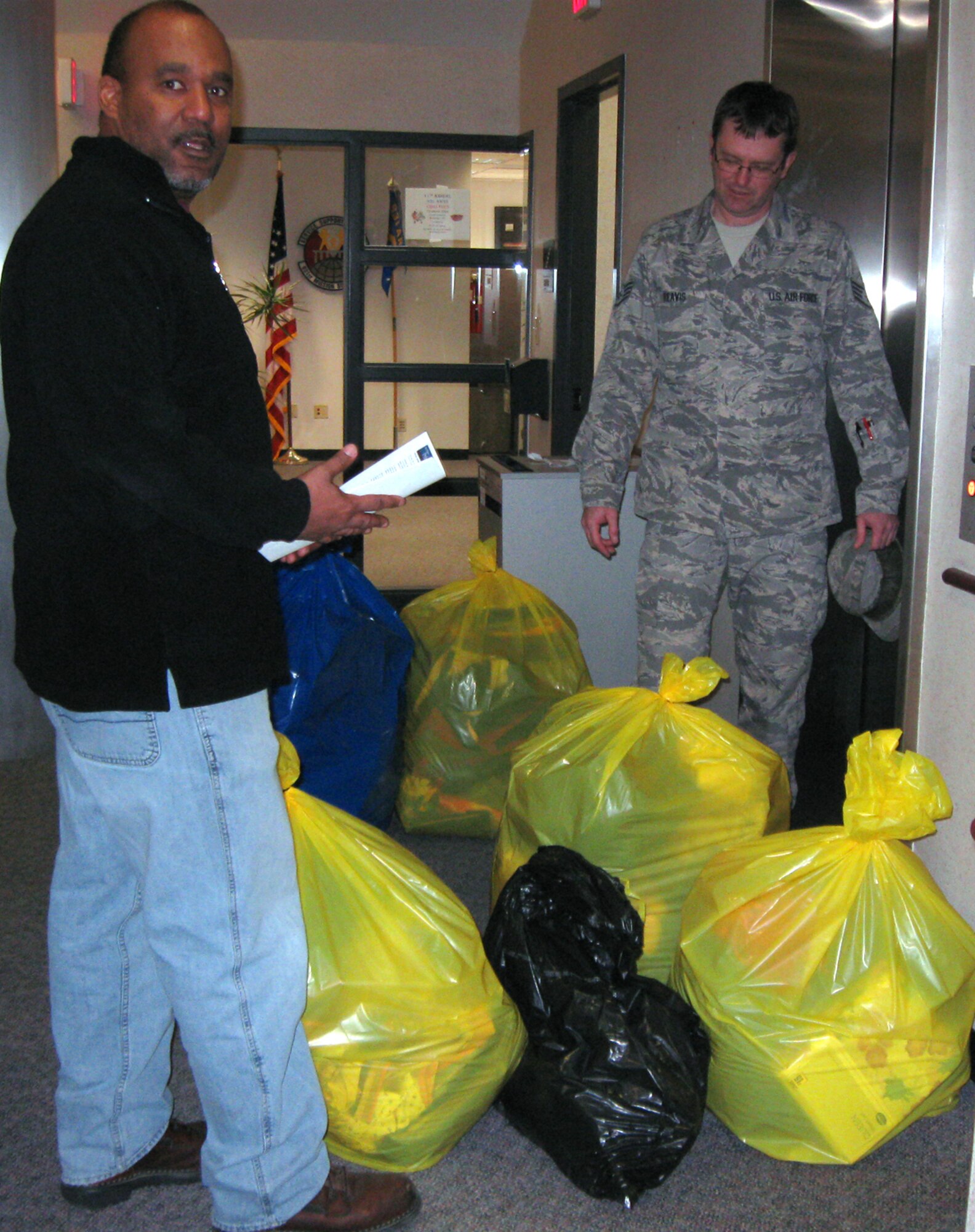 Tech. Sgt. Milt Willhight (on left) and Staff Sgt. Mke Reavis help move bags of donations bound for Harbor House, a shelter that assists domestic abuse victims. The 931st Human Resource Development Council sponsored a drive to collect clothes and other items donated by members of the 931st Air Refueling Group, an Air Force Reserve unit at McConnell Air Force Base, Kan. The donations were delivered to Harbor House on Jan. 29. Sergeant's Willhight and Reavis both are HRDC members assigned to the 931st Aircraft Maintenance Squadron. (Courtesy photo)