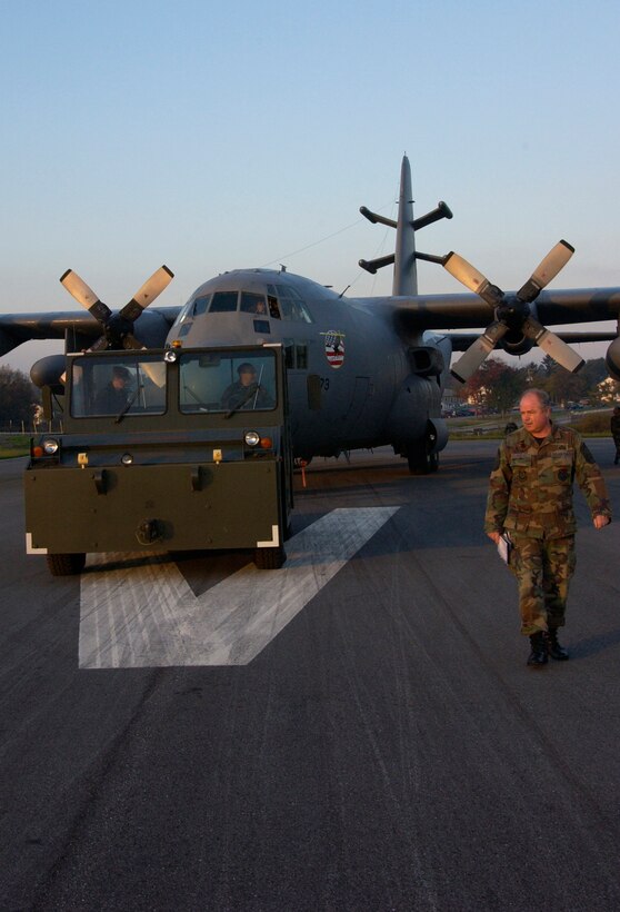 Members of the 193rd Special Operations Wing Pennsylvania Air National Guard guide an EC-130E Commando Solo down the runway at Muir Field at Fort Indiantown Gap Annville, PA. October 4, 2006.  The aircraft Affectionetly known as "The Tripple Cripple" will soon be on perminent display at the post.