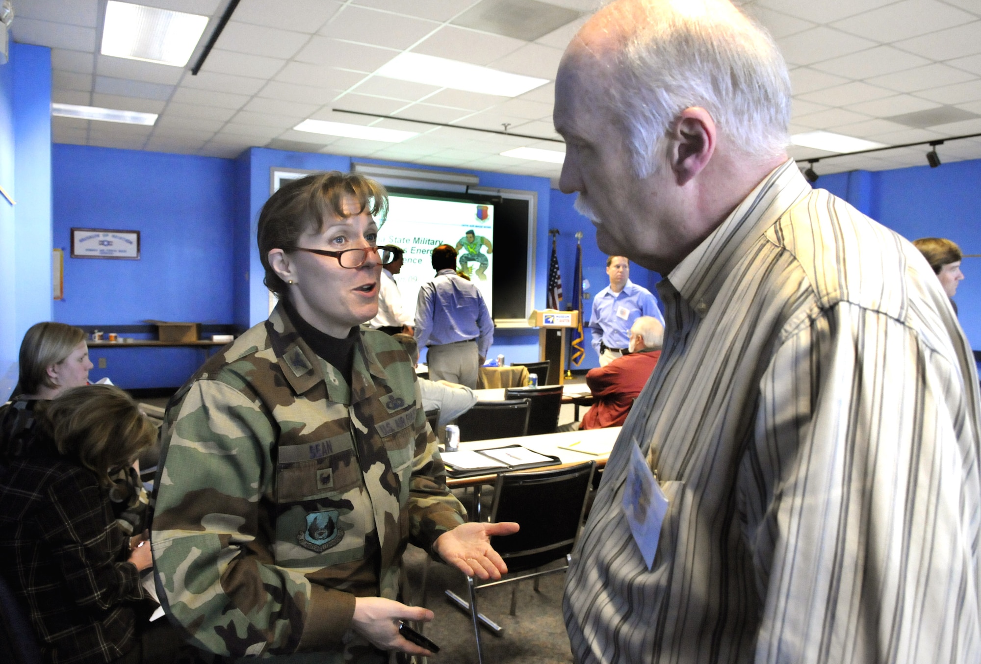 Col. Debra Bean, 78th Air Base Wing vice commander, speaks with William S. Bulpitt, Georgia Institute of Technology senior research engineer, at the Georgia State Military Installation Conference at the Museum of Aviation Jan 27. U. S. Air Force photo by Sue Sapp