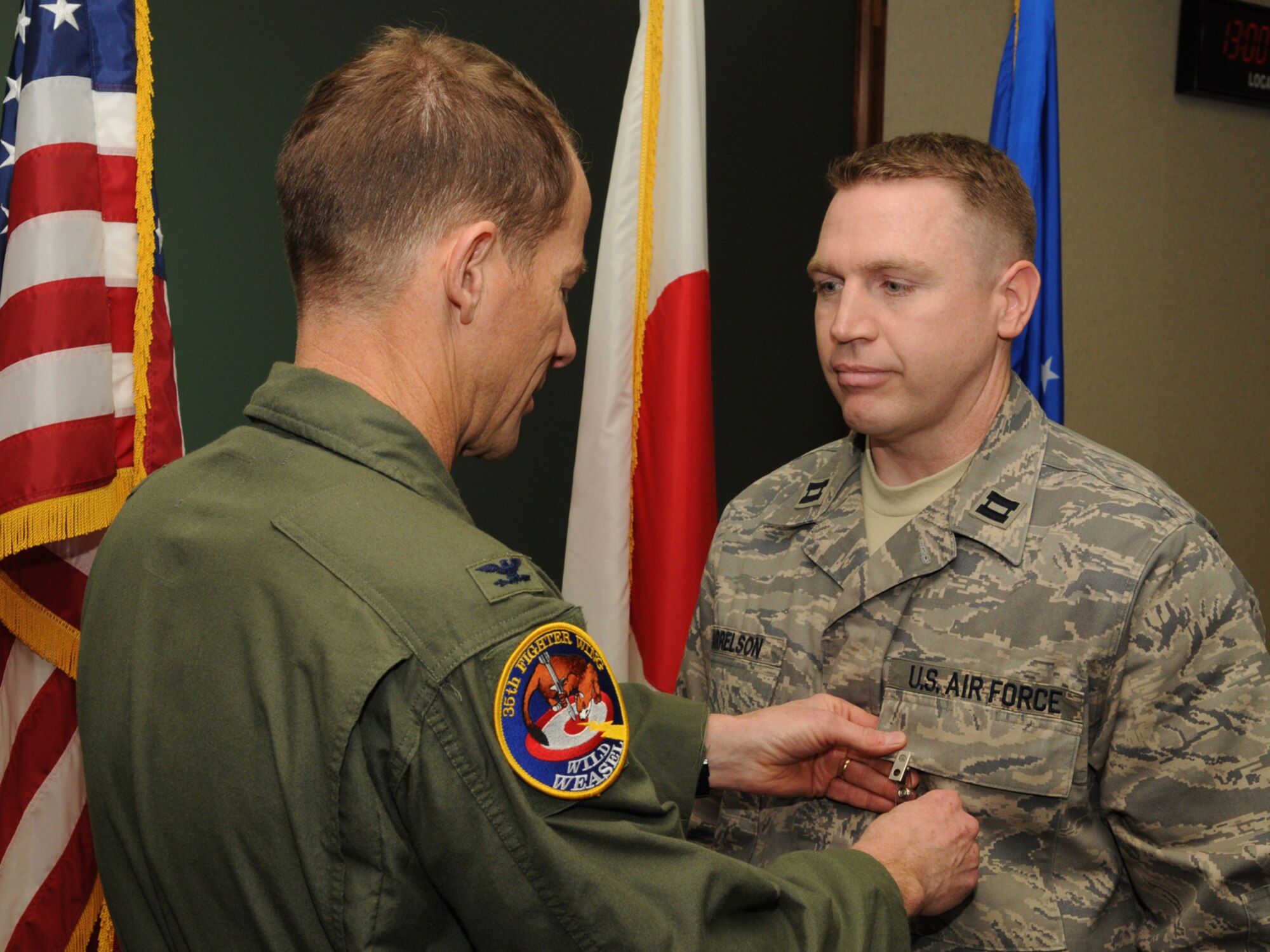 MISAWA AIR BASE, Japan -- Capt. Timothy Harrelson, 35th Medical Group family practice physician assistant, receives the Bronze Star from Col. David Stiwell, 35th Fighter Wing commander, Dec. 19, 2008. Captain Harrelson's efforts during a deployement to Forward Operating Base Lagman, Afghanistan, awarded him the medal. (U.S. Air Force photo by Senior Airman Jamal D. Sutter)