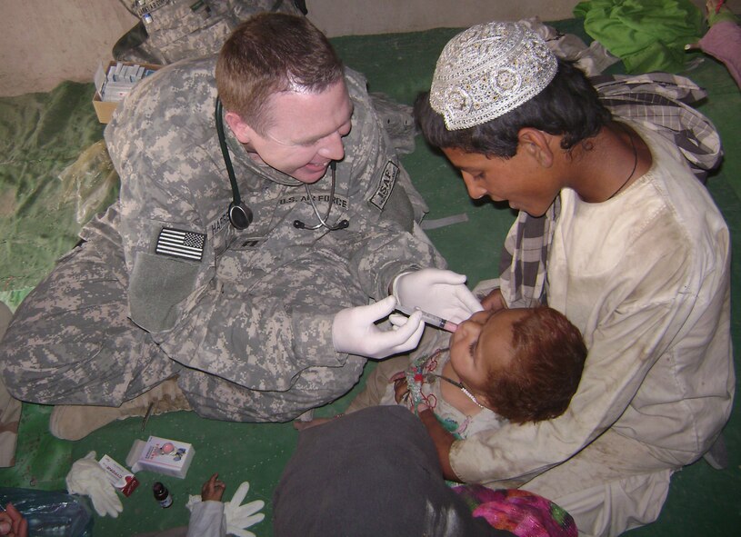 During an eight-month deployment to Afghanistan, Capt. Timothy Harrelson, family practice physician assistant, 35th Medical Operations Squadron, treats a two-year old child. For Captain Harrelson's efforts during his deployment, he was awarded the Bronze Star. (Courtesy photo)