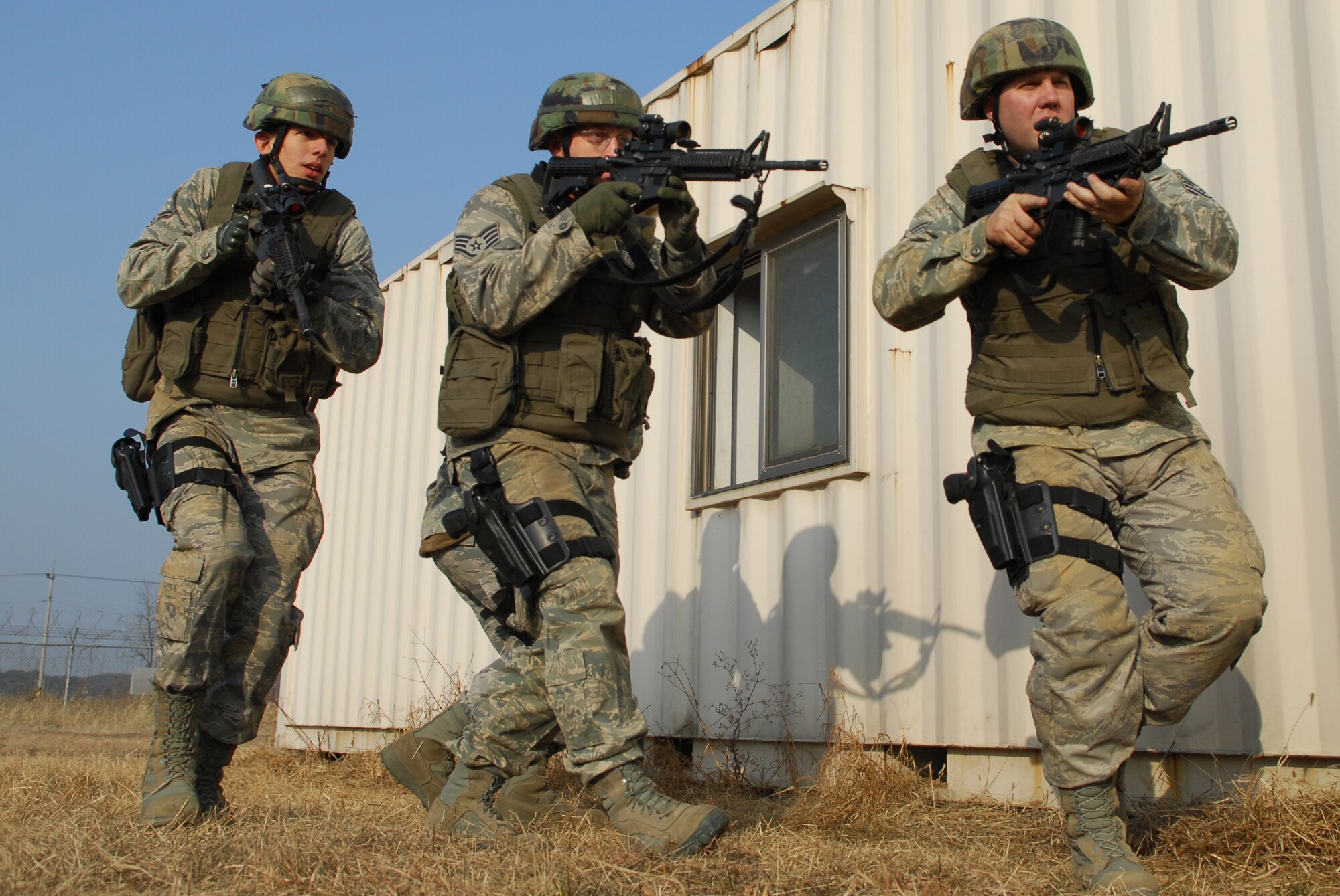 Security Forces Airmen patrol and search the exterior of a building during the 51st Security Forces Squadron combat readiness course Jan. 22 on Osan AB. Newly arriving security forces Airmen go through a six-day combat readiness course designed to prepare SF Airmen by giving them the tools needed to perform the mission. (U.S. Air Force photo/Senior Airman Christopher Boitz)