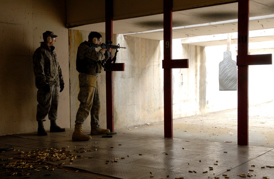 An instructor looks on as a security forces Airman attempts to qualify Jan. 22 on Osan AB.  Firing is an important part of the 51st Security Forces combat readiness course. Newly arriving security forces Airmen are put to the test in a grueling 6-day course designed to prepare SF Airmen by giving them the tools needed to perform the mission. (U.S. Air Force photo/Staff Sgt Brian Ferguson)