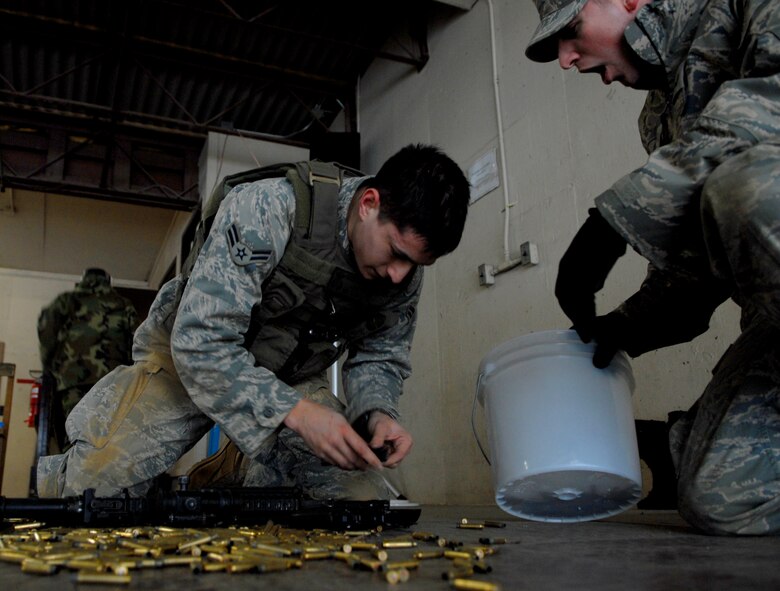 A combat readiness course instructor motivates a newly arrived security forces Airman to speed up reassembly of his M9 pistol Jan. 22 during the 51st Security Forces Squadron's combat readiness course at Osan AB. Newly arriving security forces Airmen go through a six-day combat readiness course designed to prepare SF Airmen by giving them the tools needed to perform the mission. (U.S. Air Force photo/Staff Sgt Brian Ferguson)