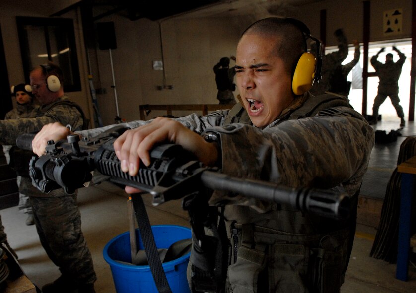 Staff Sgt. Christopher Galbadores strains as he holds his M4 rifle at arm’s length before firing at the Osan Air Base range Jan 22. Weapons qualification training is part of the 51st Security Forces Squadron's six-day combat readiness course designed to prepare SF Airmen by giving them the tools needed to perform the mission. Sergeant Galbadores is assigned to the 51 SFS. (U.S. Air Force photo/Staff Sgt Brian Ferguson)