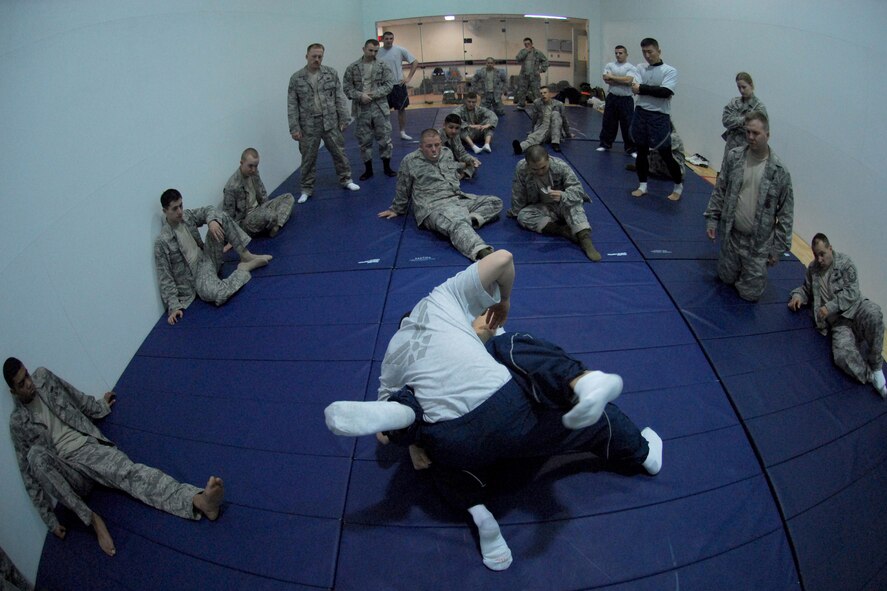 Instructors from the 51st Security Forces Squadron demonstrate hand-to-hand combat skills to a group of newly arriving security forces Airmen Jan. 21 at Osan AB.  This combatives class is part of the 51st Security Forces Squadron's combat readiness course designed to prepare SF Airmen by giving them the tools needed to perform the mission. (U.S. Air Force photo/Senior Airman Christopher Boitz)