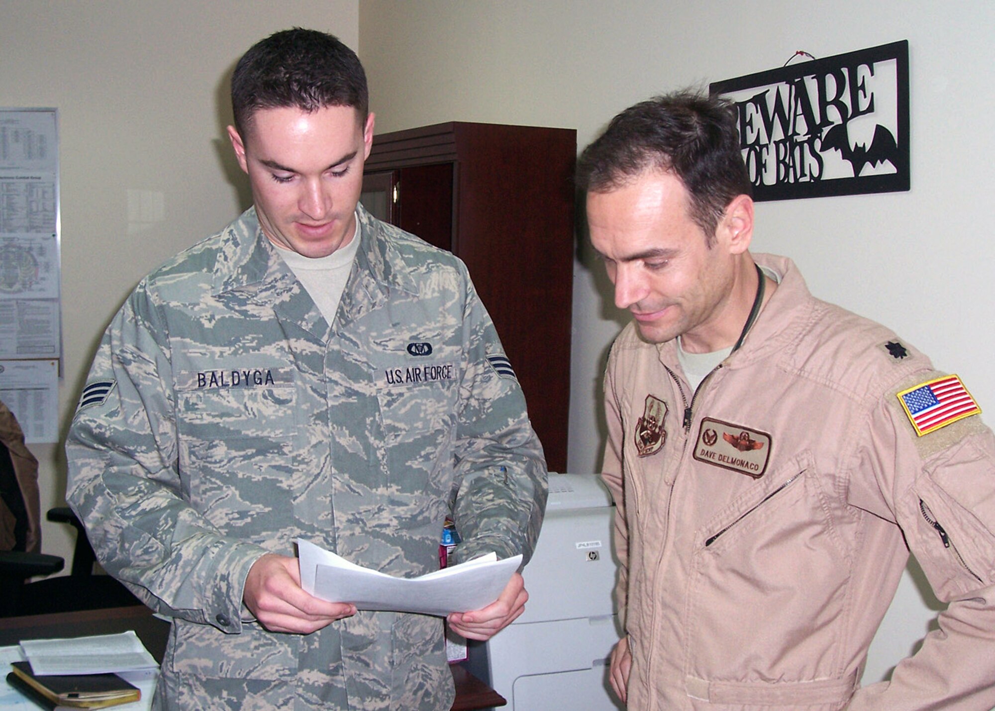 SOUTHWEST ASIA -- Senior Airman Jason Baldyga, 43rd Expeditionary Electronic Combat Squadron aviation resource management technician, briefs his commander, Lt. Col. Dave Delmonaco on training requirements and flight hours. Airman Baldyga is deployed from the 43rd Electronic Combat Squadron at Davis-Monthan Air Force Base, Ariz. (U.S. Air Force courtesy photo) 