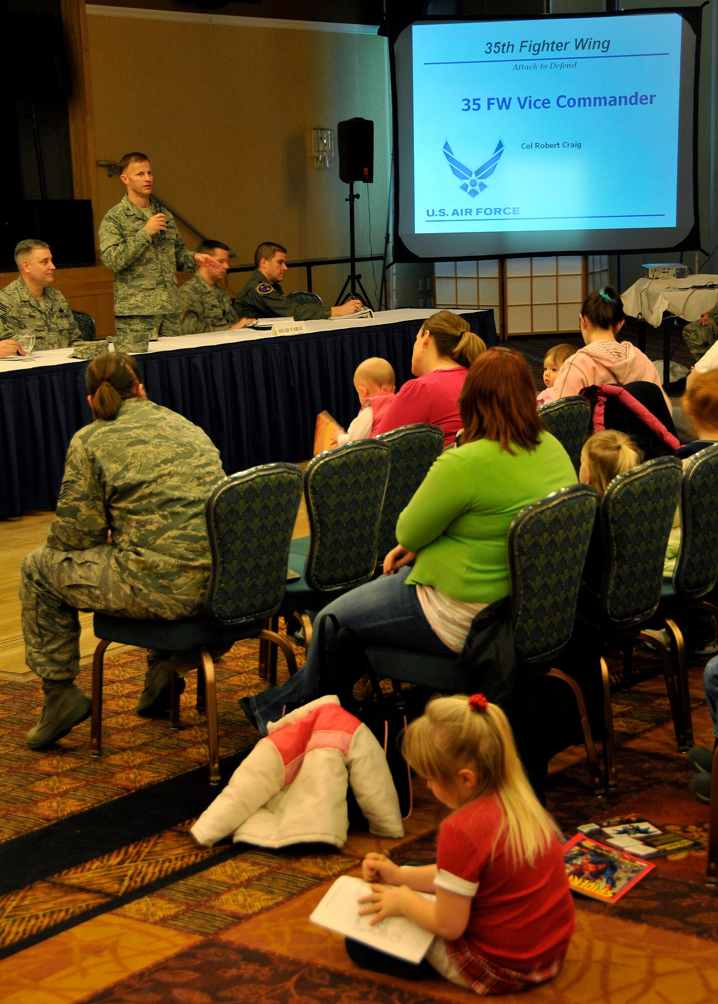 MISAWA AIR BASE, Japan -- During the base town hall meeting, Col. Robert Craig, 35th Fighter Wing vice commander, briefs the responsibilities of both servicemembers and the families during a deployment Jan. 29, 2009. Town hall meetings are important because it gives Misawa personnel a chance to communicate directly with the wing leadership. (U.S. Air Force photo by Senior Airman Chad Strohmeyer)