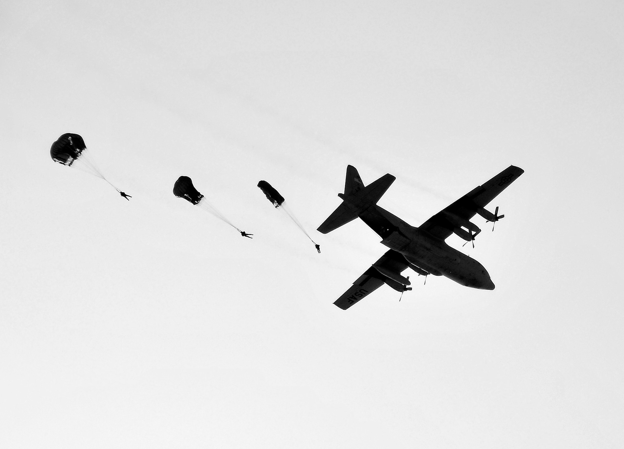MISAWA AIR BASE, Japan -- Survival, Evasion, Resistance and Escape instructors and a pararescueman parachute out of a C-130 Hercules at 1,250 feet Jan. 22, 2009.  The jump provided a training opportunity for the aircrew and the special forces personnel.  (U.S. Air Force photo by Senior Airman Chad Strohmeyer)