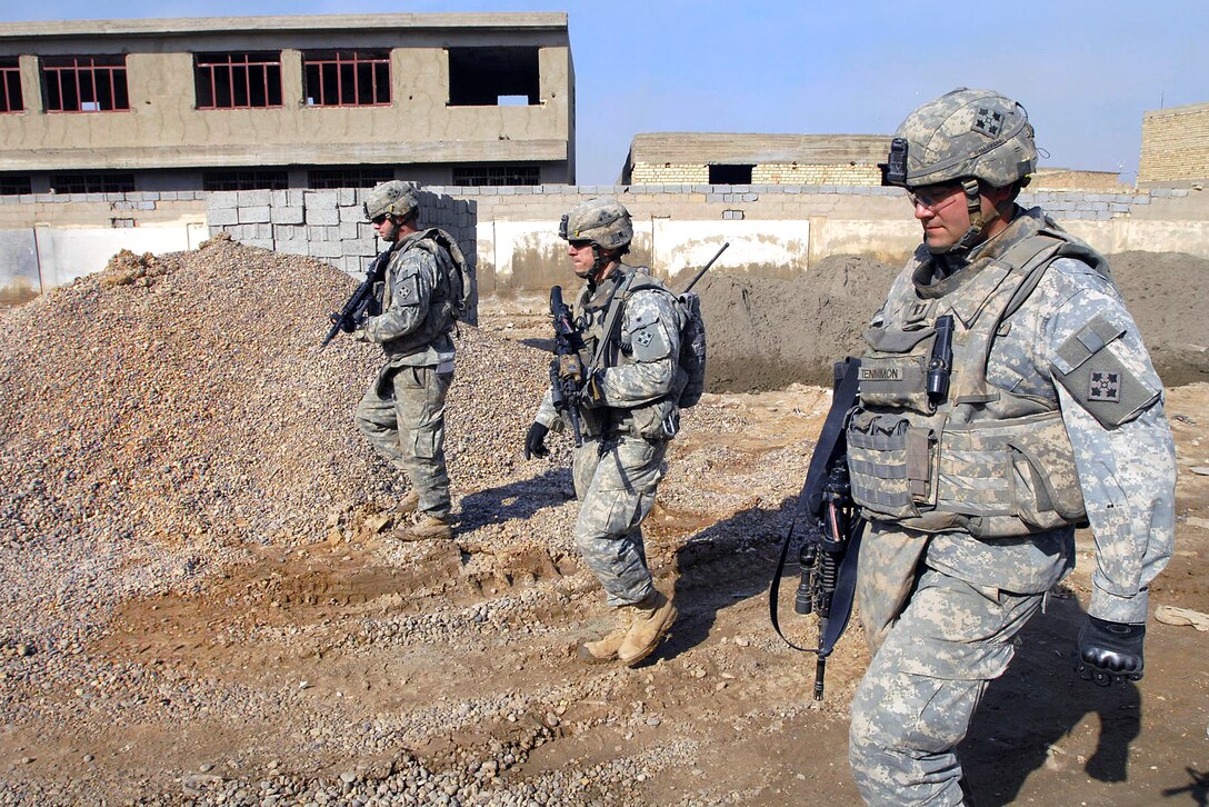 U.S. Army Staff Sgt. David Pena, left, Sgt. 1st Class Thomas Yaudas, center and Capt. Sean Tennimon, conduct reconnaissance operations in the Abu T'shir community of the Rashid district in southern Baghdad, Iraq, Jan. 28, 2009.