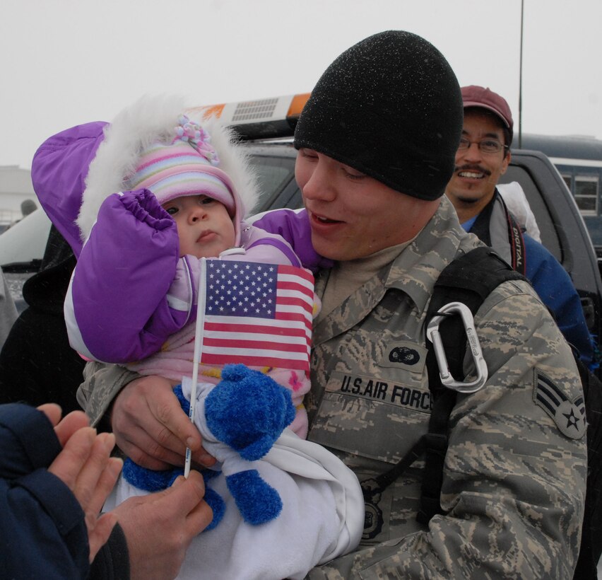 NIAGARA FALLS AIR RESERVE STATION, N.Y. - Family and friends greet Air Force Reserve Senior Airman Shane Williams as he returns home from a six month deployment to Iraq where the temperature upon arrival in the AOR was 120 degrees.  Williams and ten other members of the 914th Security Forces Squadron returned home to Western New York in January to below freezing temperatures and snow.  (U.S. Air Force photo by Mr. Michael Harvey)