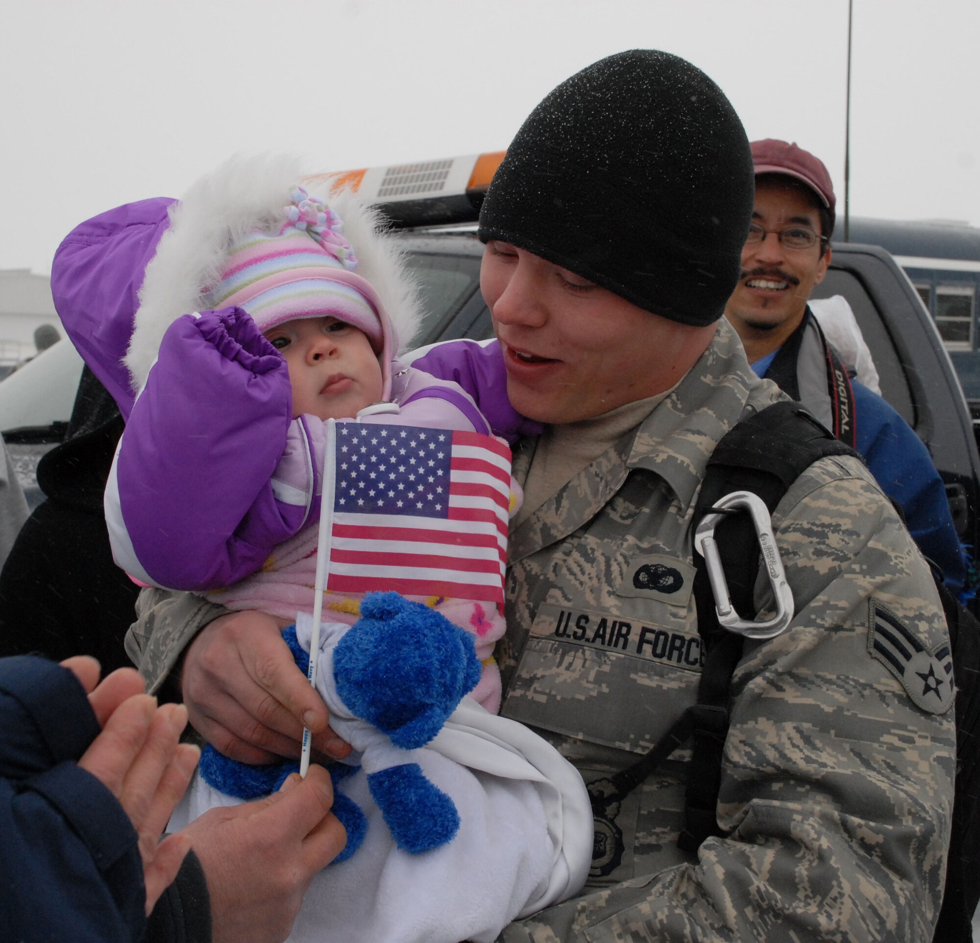 NIAGARA FALLS AIR RESERVE STATION, N.Y. - Family and friends greet Air Force Reserve Senior Airman Shane Williams as he returns home from a six month deployment to Iraq where the temperature upon arrival in the AOR was 120 degrees.  Williams and ten other members of the 914th Security Forces Squadron returned home to Western New York in January to below freezing temperatures and snow.  (U.S. Air Force photo by Mr. Michael Harvey)