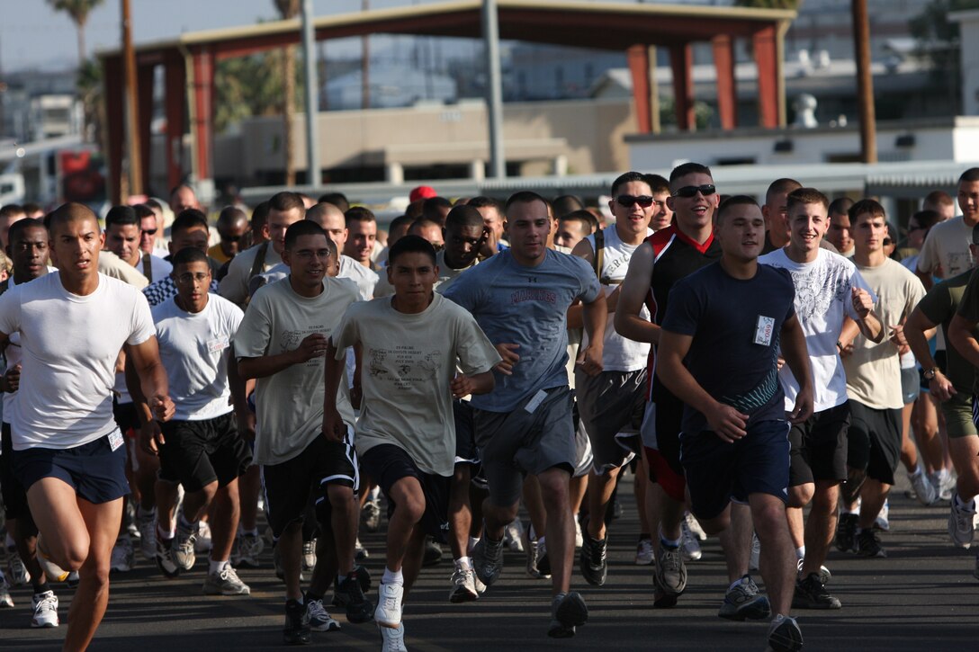 Marines, sailors, family members and civilians take off at the sound of the air horn during the first 5K Coyote Desert Fun Run hosted by the Installation Personnel Administration Center of Headquarters Battalion at Victory Field July 2. The run helped raise money for junior Marines in up-coming trips.