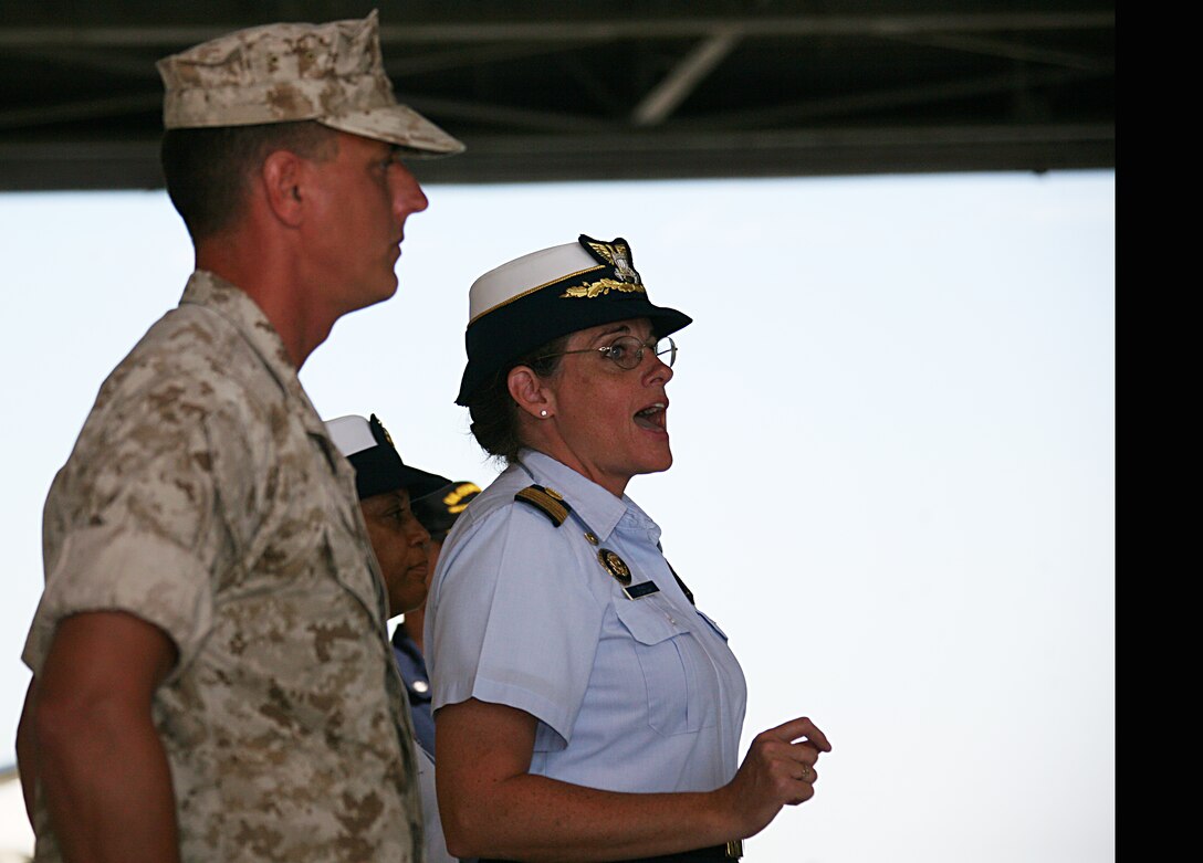 Navy Capt. June Ryan, Coast Guard Sector North Carolina commander, and Marine Transport Squadron 1’s commander, Lt. Col. Wayne Bunker, address the VMR-1 squadron formation in an award ceremony, July 1 aboard Cherry Point, N.C. The squadron received a Coast Guard Meritorious Unit Citation for aiding the Coast Guard in rescue operations in eastern North Carolina.
