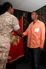 Chief Warrant Officer 4 Nicole Holt, 9th Marine Corps District headquarters personnel officer, shakes hands with her son, Rhaashid Thompson, after his oath of enlistment July 1. Thompson has two parents who have both served nearly 20 years in the Marine Corps. Thompson is looking to give the Corps four years as a data network technician.