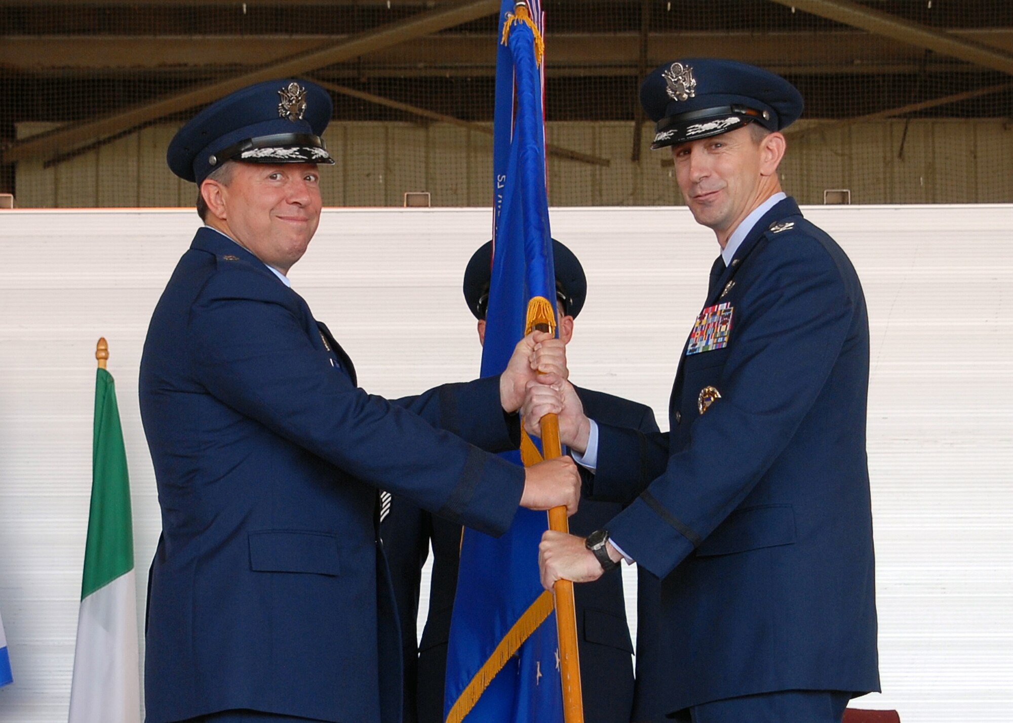 Col. Kevin Schneider accepts command of the 80th Flying Training Wing from 19th Air Force Commander Maj. Gen. Gregory Feest during the change of command ceremony July 1. The outgoing commander is Col. David Petersen. (U.S. Air Force photo/Mike Litteken)