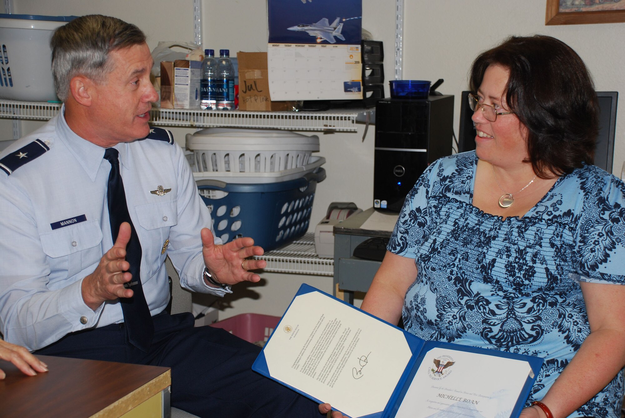 Brig. Gen. O.G. Mannon (left), 82nd Training Wing commander, talks to Michelle Roan, manager of Sheppard's Thrift Store, about her importance to helping out Sheppard families. Mrs. Roan was awarded the President's Volunteer Service Award July 1. (U.S. Air Force photo/John Ingle)