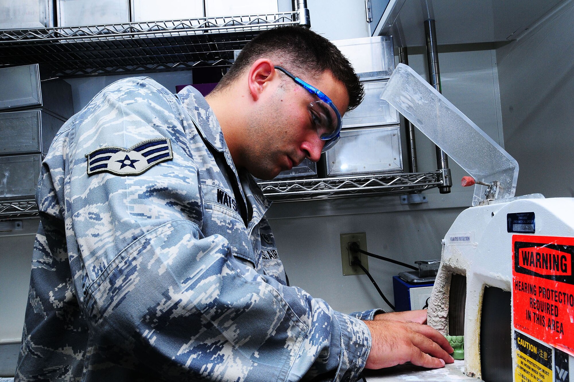 YOKOTA AIR BASE, Japan--Senior Airman Mike Watson, 374th Dental Squadron dental laboratory technician, trims a stone cast that will be used as a mold for an acrylic retainer June 26. The dental laboratory specializes in making crowns, dentures, retainers, and bridges for their patients.  (U.S. Air Force photo/Airman 1st Class Sean Martin)