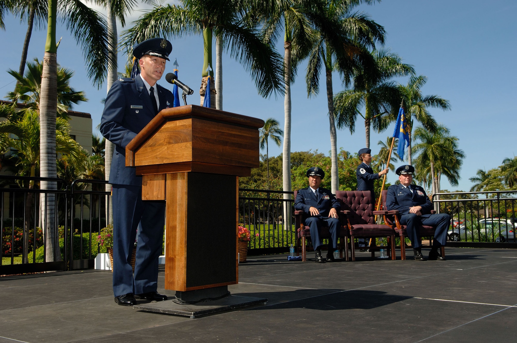 HICKAM AIR FORCE BASE, Hawaii -- Col. Jeffery W. Morgan gives an incoming address during the 15th Operations Group Change of Command ceremony June 30. Colonel Morgan was the Director of Combat Capabilities, Headquarters Air Mobility Command, Scott Air Force Base, Ill. Also on the platform are Col. Giovanni Tuck, 15th Airlift Wing commander, and Col. Andrew M. Hockman, outgoing 15th OG commander. (U.S. Air Force photo/Mark Bates)