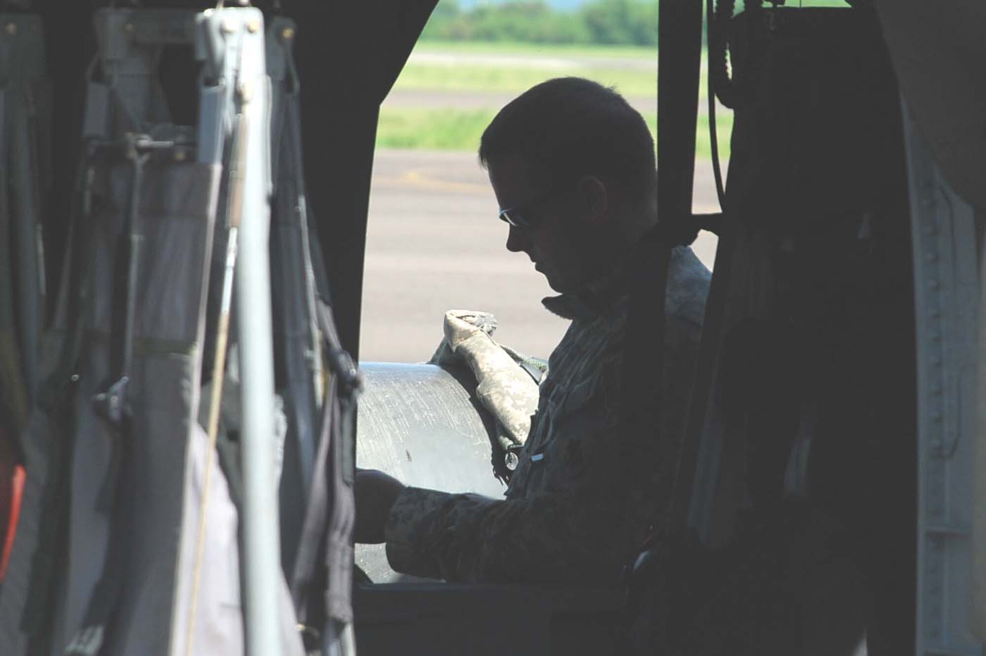 SOTO CANO AIR BASE, Honduras — Army Chief Warrant Officer Derek Griblin, 1st Battalion, 228th Aviation Regiment, runs through a pre-flight checklist before takeoff here today. The Blackhawk crew, along with two other helicopters assigned to Joint Task Force-Bravo, will support the hospital ship USNS Comfort’s humanitarian and civic assistance mission in Nicaragua. (U.S. Air Force photo by Staff Sgt. Chad Thompson).